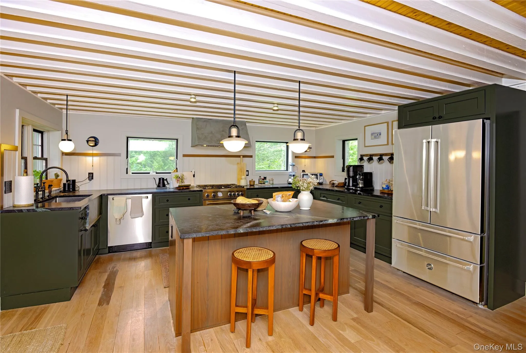 Large island kitchen with professional appliances, abundant granite counter space and a breakfast bar. Large island kitchen with professional appliances, abundant granite counter space and a breakfast bar.