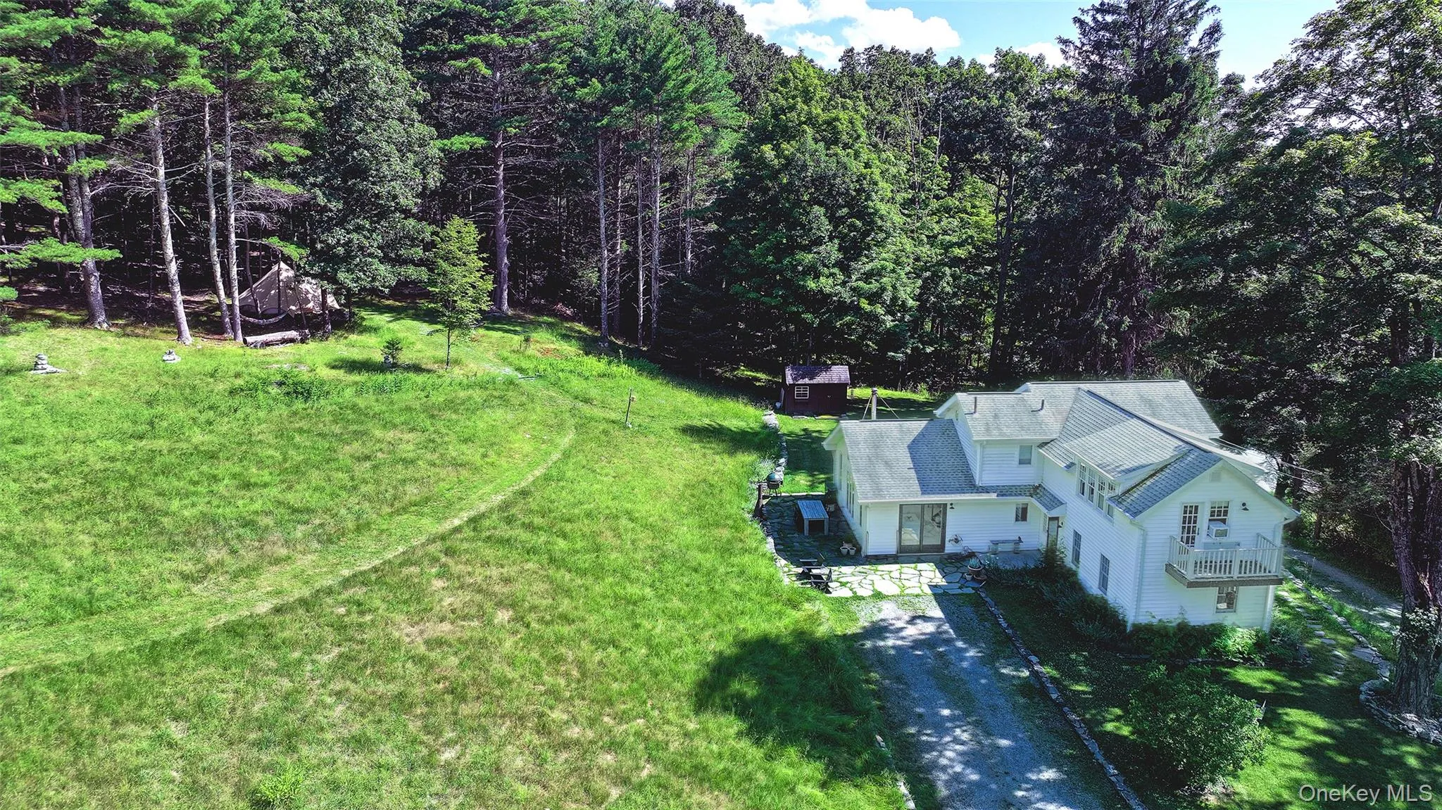 Aerial view of the woods with the camping area on the hillside to the woodlands south of the house and driveway. Aerial view of the woods with the camping area on the hillside to the woodlands south of the house and driveway.