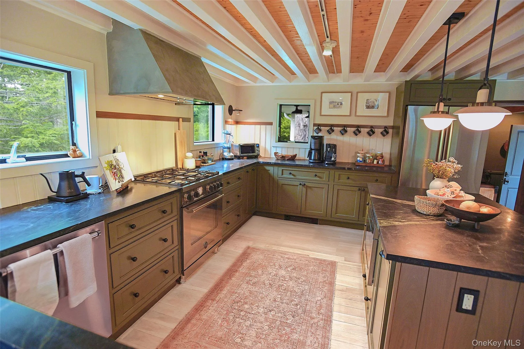 Kitchen's primary work area showing granite counters, stainless steel appliances, and storage areas. Kitchen's primary work area showing granite counters, stainless steel appliances, and storage areas.