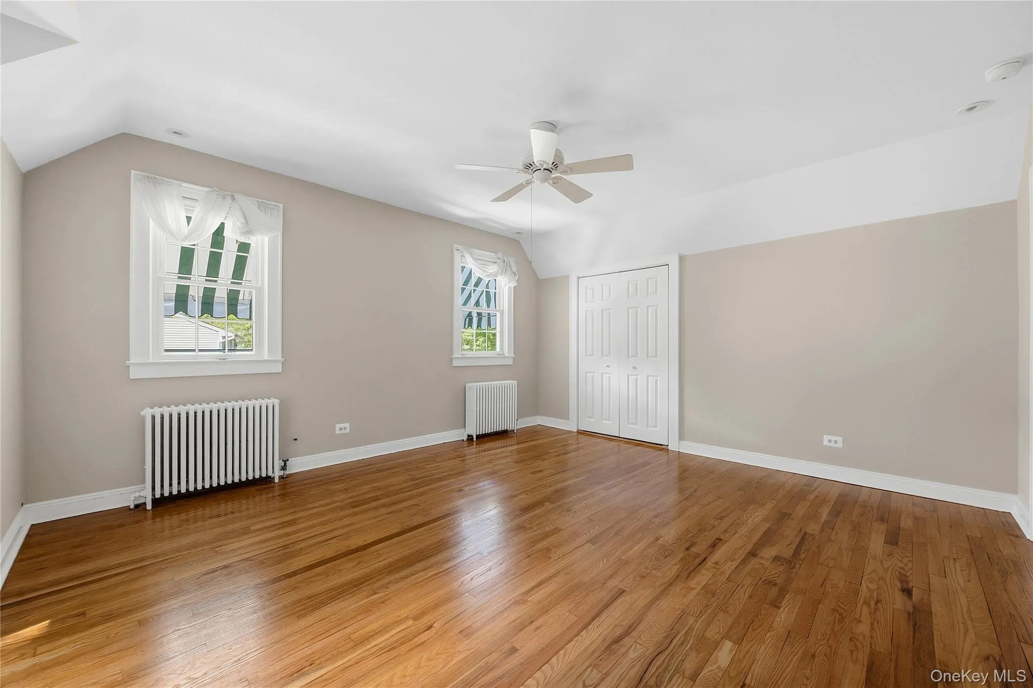 Alternate view of Bedroom with ceiling fan and newly refinished hardwood floors Alternate view of Bedroom with ceiling fan and newly refinished hardwood floors