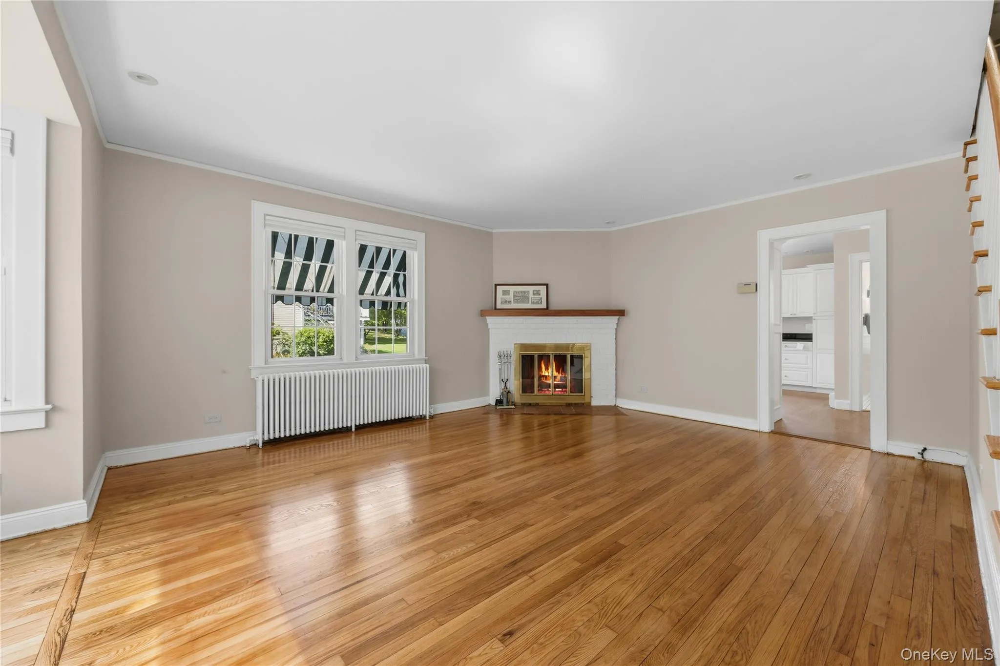 Beautiful and sunlit living room room with corner wood-burning fireplace. Beautiful and sunlit living room room with corner wood-burning fireplace.