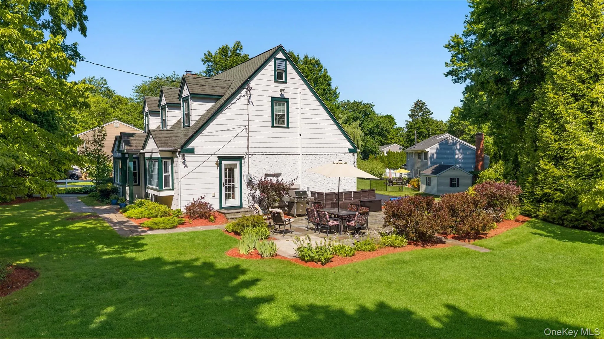 A side view of your future home which shows a patio, beautiful landscaping and an impressive yard! A side view of your future home which shows a patio, beautiful landscaping and an impressive yard!