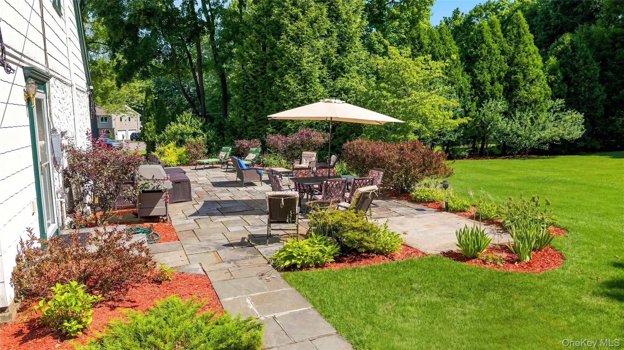 Close-up of the flagstone Patio with perennial plantings on the border. Great for entertaining with a door out from the side of the house. Close-up of the flagstone Patio with perennial plantings on the border. Great for entertaining with a door out from the side of the house.
