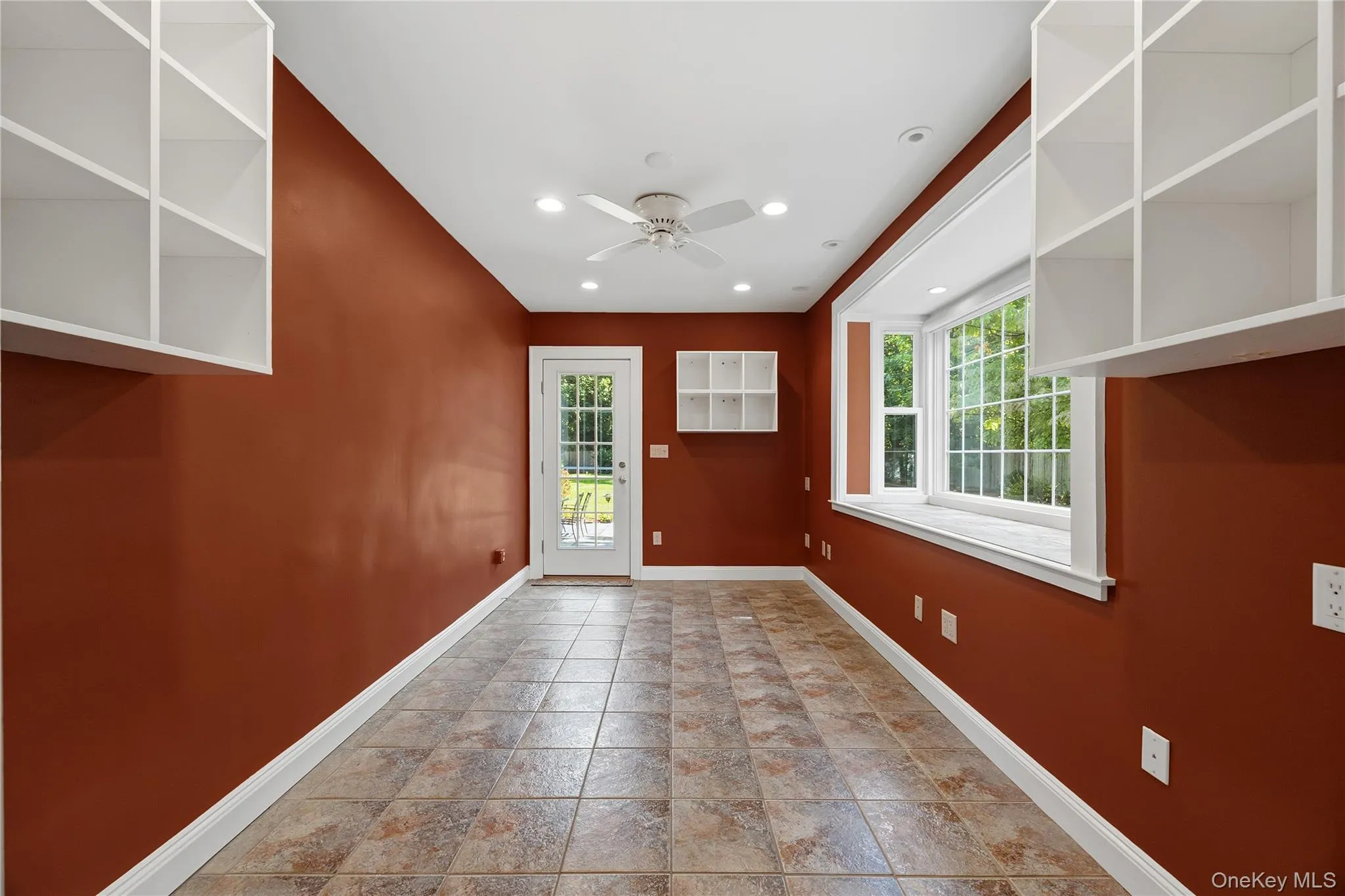 More space on the main level: The current owners used this room as an Office with built-in shelves and a separate entrance. More space on the main level: The current owners used this room as an Office with built-in shelves and a separate entrance.