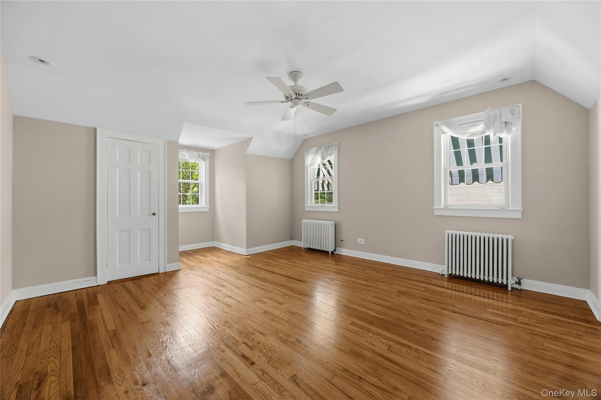 Gleaming hardwood floors in the spacious Primary Bedroom Gleaming hardwood floors in the spacious Primary Bedroom