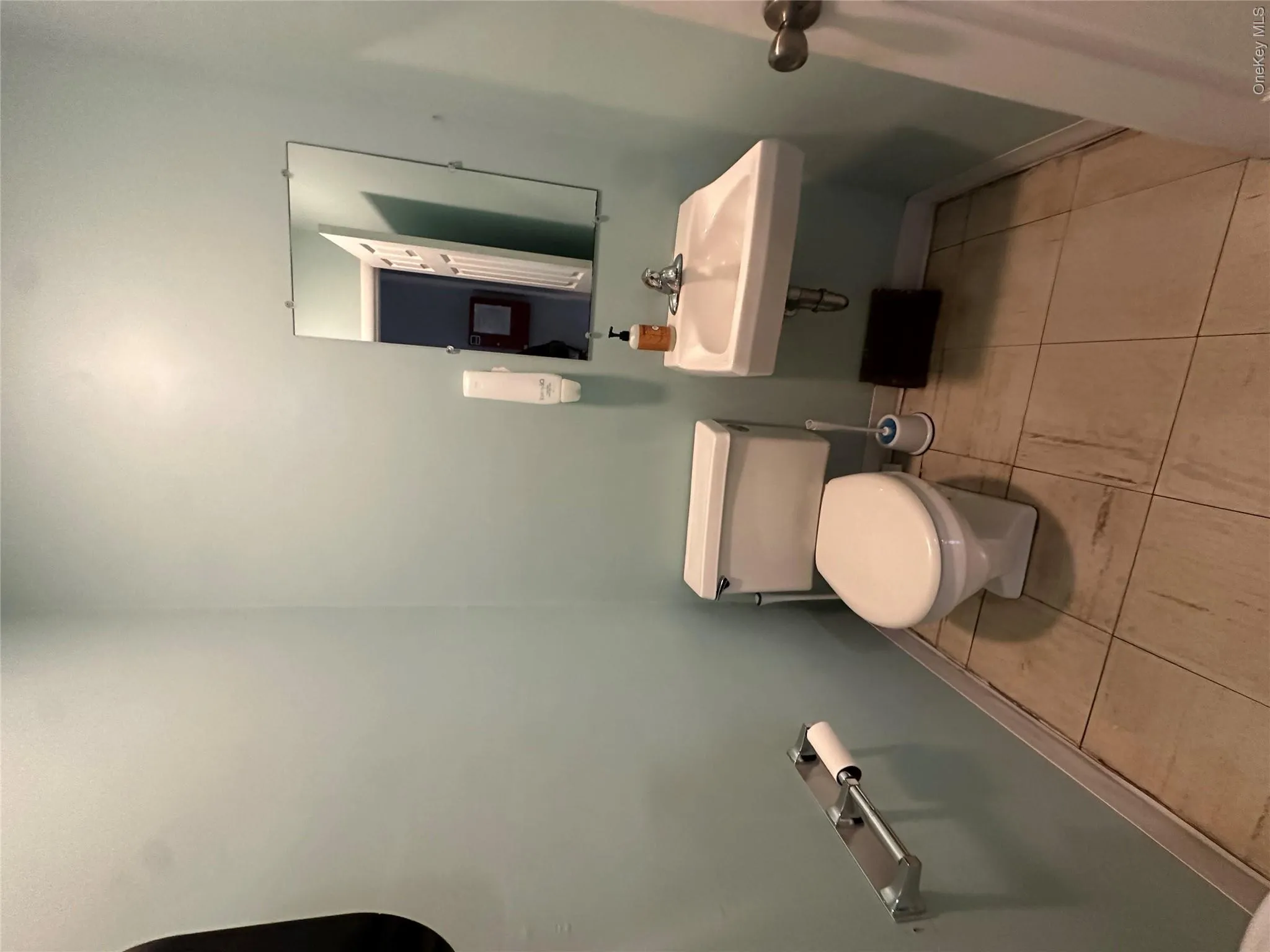Half bath with light tile patterned floors Half bath with light tile patterned floors