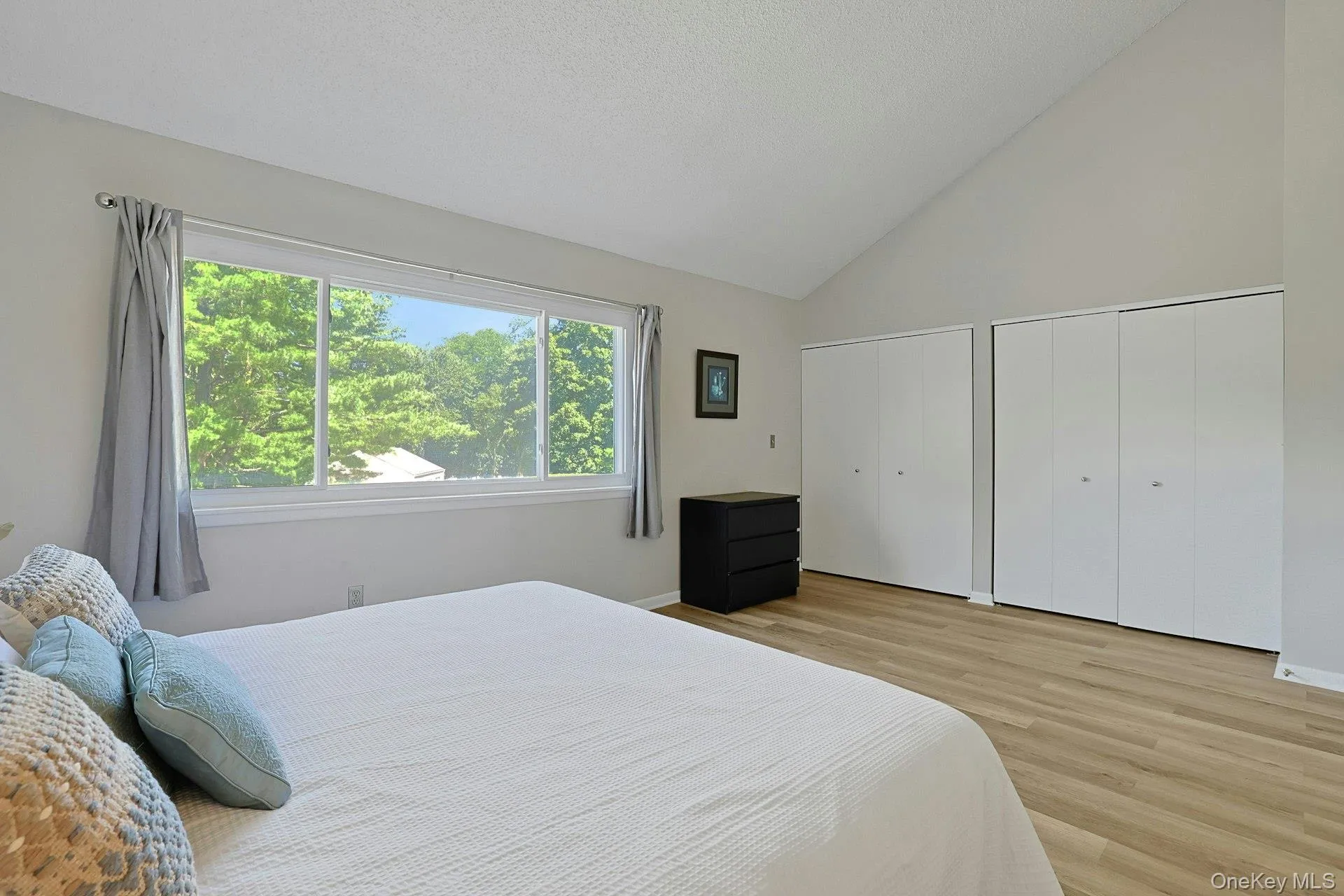 The primary bedroom features beautiful cathedral ceilings along with two large closets offering excellent storage. The primary bedroom features beautiful cathedral ceilings along with two large closets offering excellent storage.