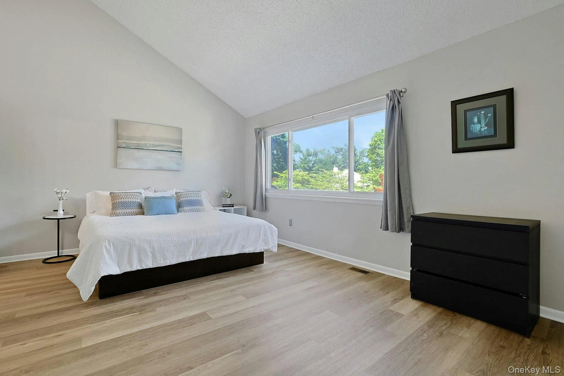 A bright primary bedroom with a large window that enhances the space with natural light. A bright primary bedroom with a large window that enhances the space with natural light.