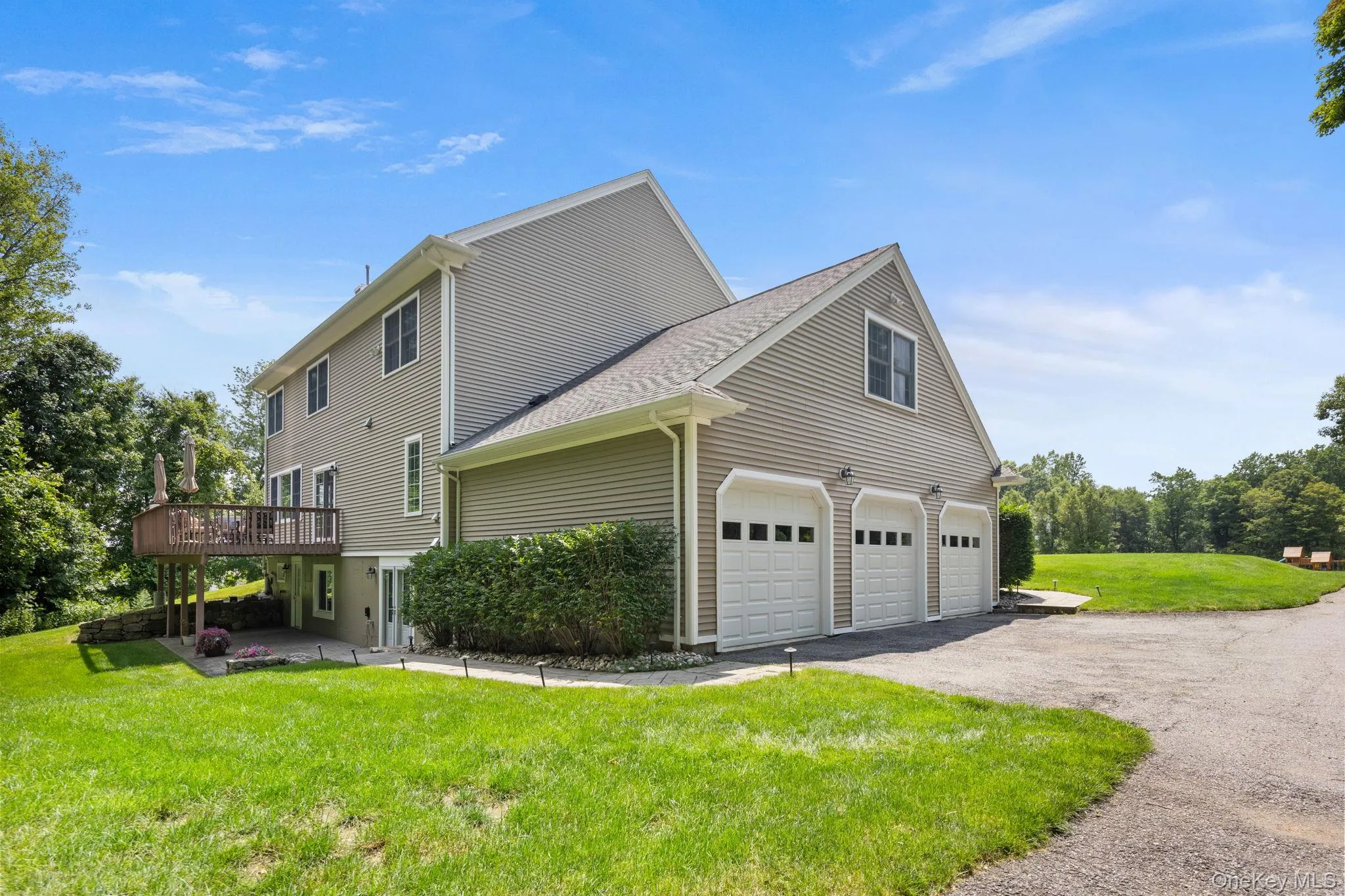 A spacious home nestled on over an acre of beautifully manicured grounds, featuring a three-car garage and an expansive paved driveway that offers ample parking and exceptional curb appeal. A spacious home nestled on over an acre of beautifully manicured grounds, featuring a three-car garage and an expansive paved driveway that offers ample parking and exceptional curb appeal.