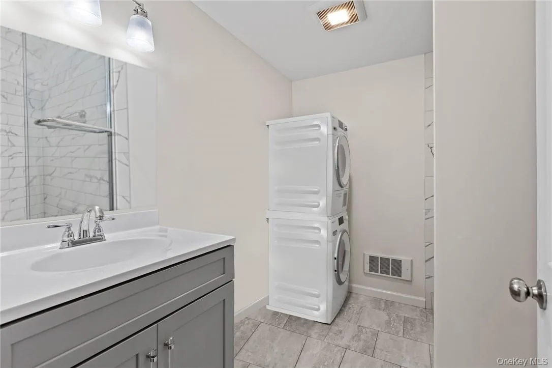 Lovely bathroom with vanity, task lighting and washer and dryer Lovely bathroom with vanity, task lighting and washer and dryer