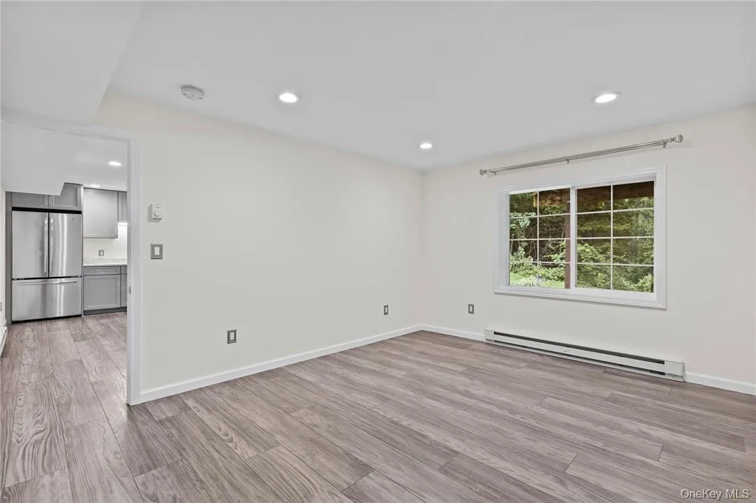 Spacious bedroom with laminate flooring and large window Spacious bedroom with laminate flooring and large window