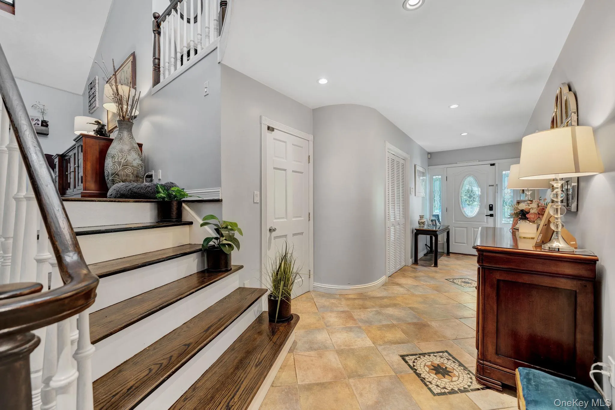 Stairs up to the dining room and door to attached 2 car garage Stairs up to the dining room and door to attached 2 car garage