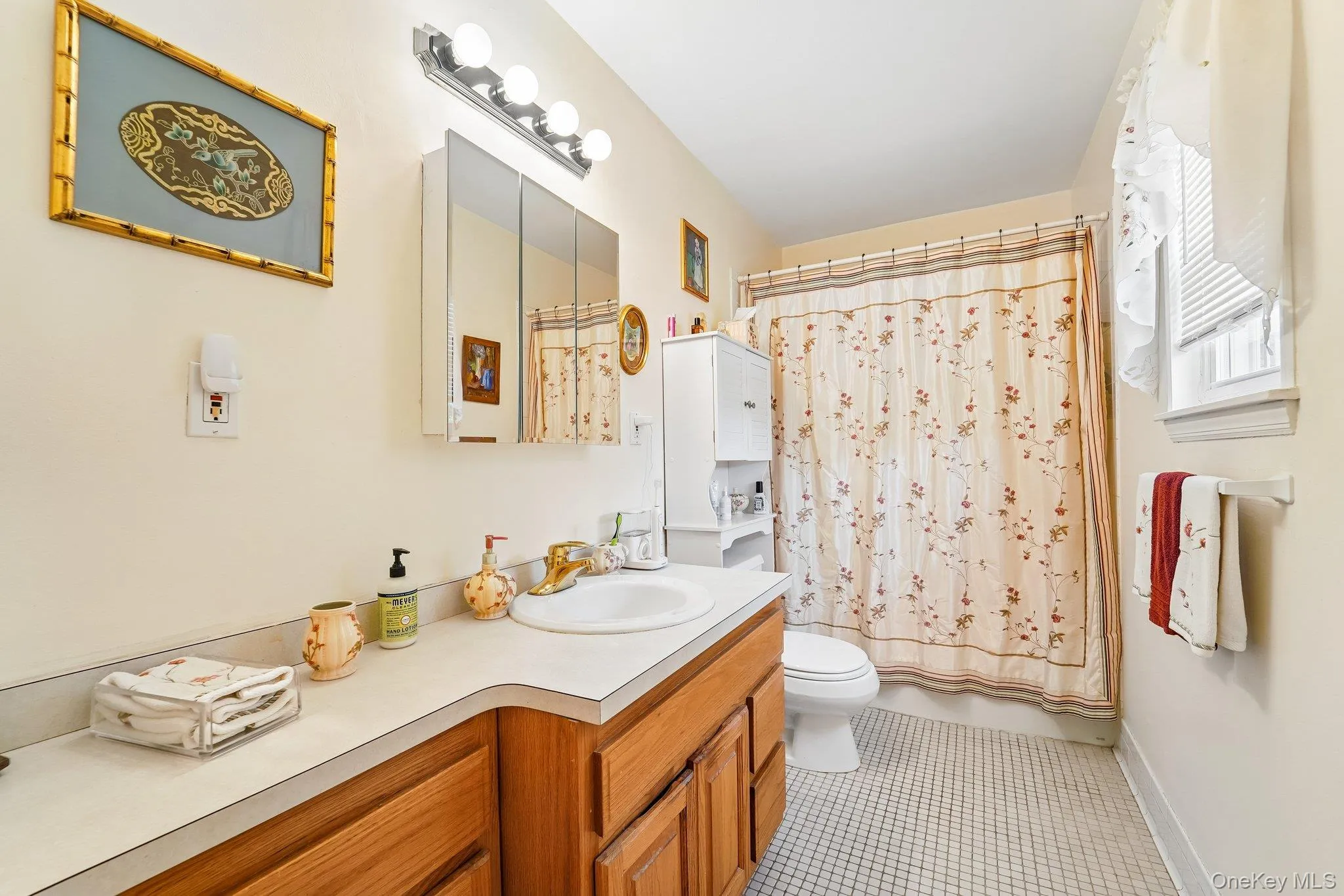 Tasteful decor, soaking tub, window with view, medicine cabinet, and ceramic tile floor. Tasteful decor, soaking tub, window with view, medicine cabinet, and ceramic tile floor.