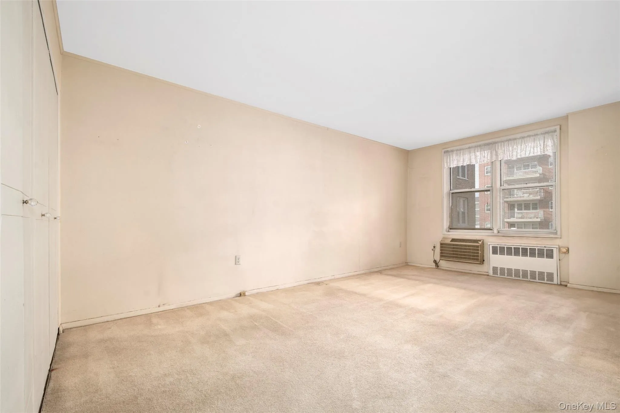 Spacious primary bedroom has built-in air conditioner and a large closet. Spacious primary bedroom has built-in air conditioner and a large closet.