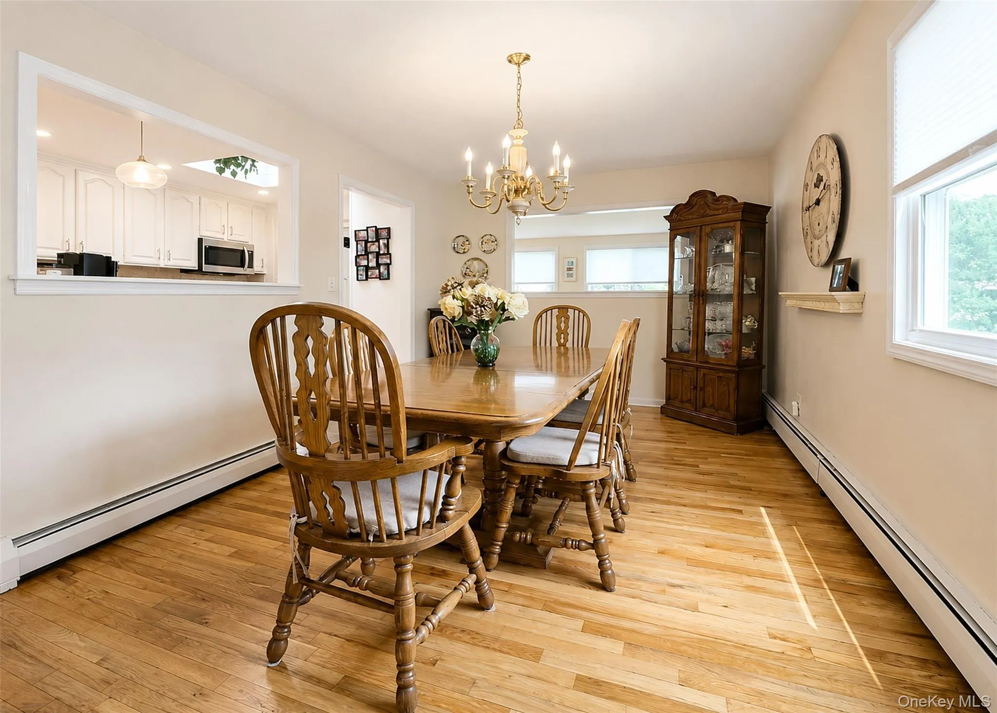 Upper Level - Sun-Lit Formal Dining Rm With Ornate Chandelier & HW Flooring. Upper Level - Sun-Lit Formal Dining Rm With Ornate Chandelier & HW Flooring.