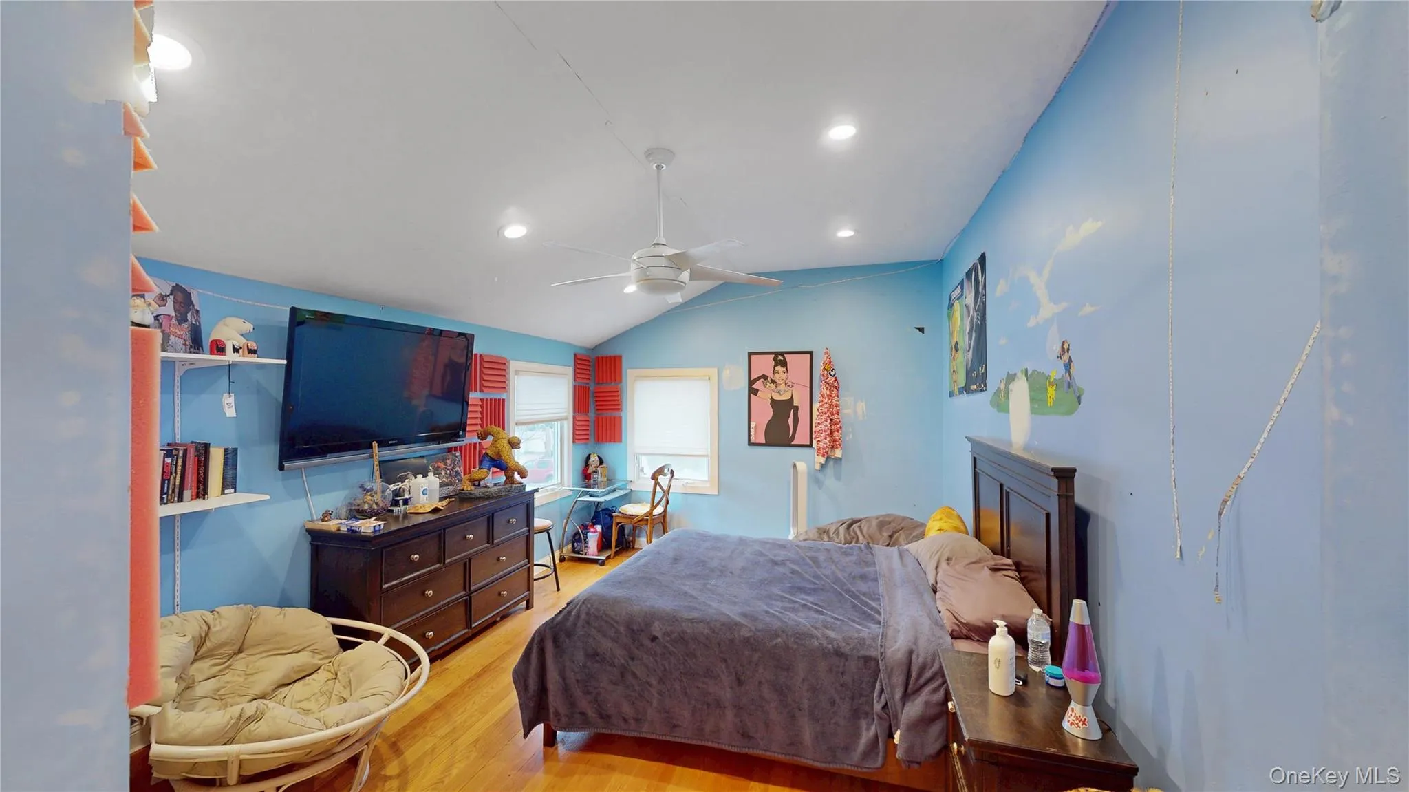 Vaulted ceiling room featuring hardwood flooring and recessed lighting Vaulted ceiling room featuring hardwood flooring and recessed lighting