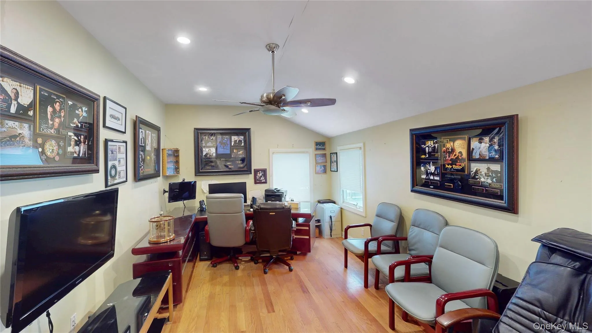 Room featuring wood-finish flooring, a vaulted ceiling, recessed lighting, and a ceiling fan Room featuring wood-finish flooring, a vaulted ceiling, recessed lighting, and a ceiling fan