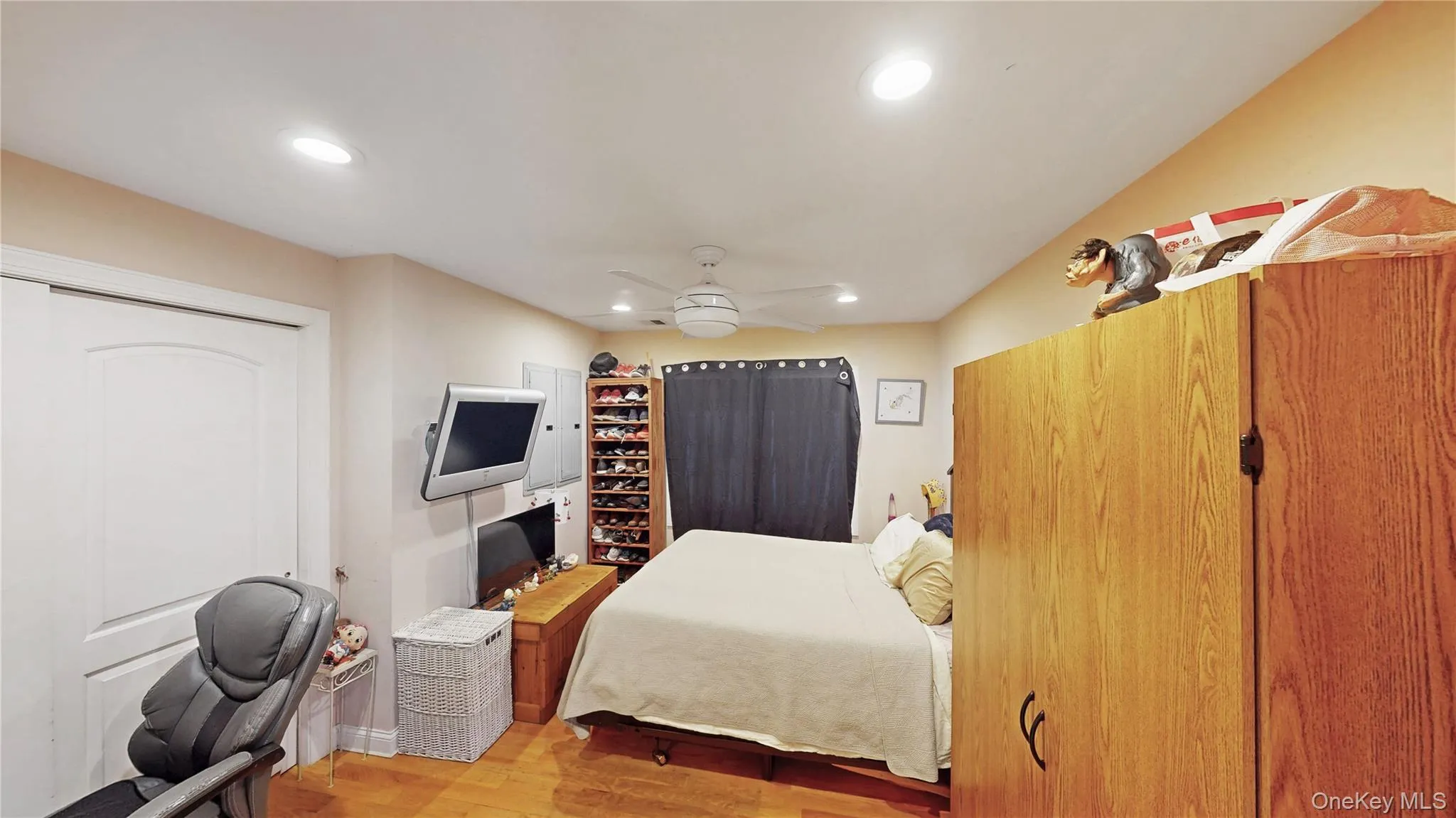 Interior room featuring wood-finish flooring, recessed lighting, and a ceiling fan Interior room featuring wood-finish flooring, recessed lighting, and a ceiling fan
