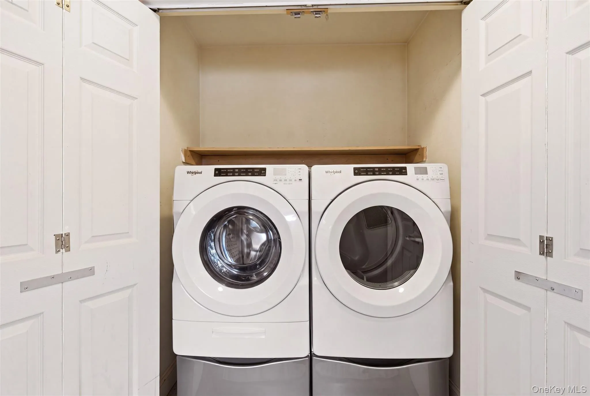 Laundry on first floor by powder room. Photo adjusted to remove shelving and supplies Laundry on first floor by powder room. Photo adjusted to remove shelving and supplies