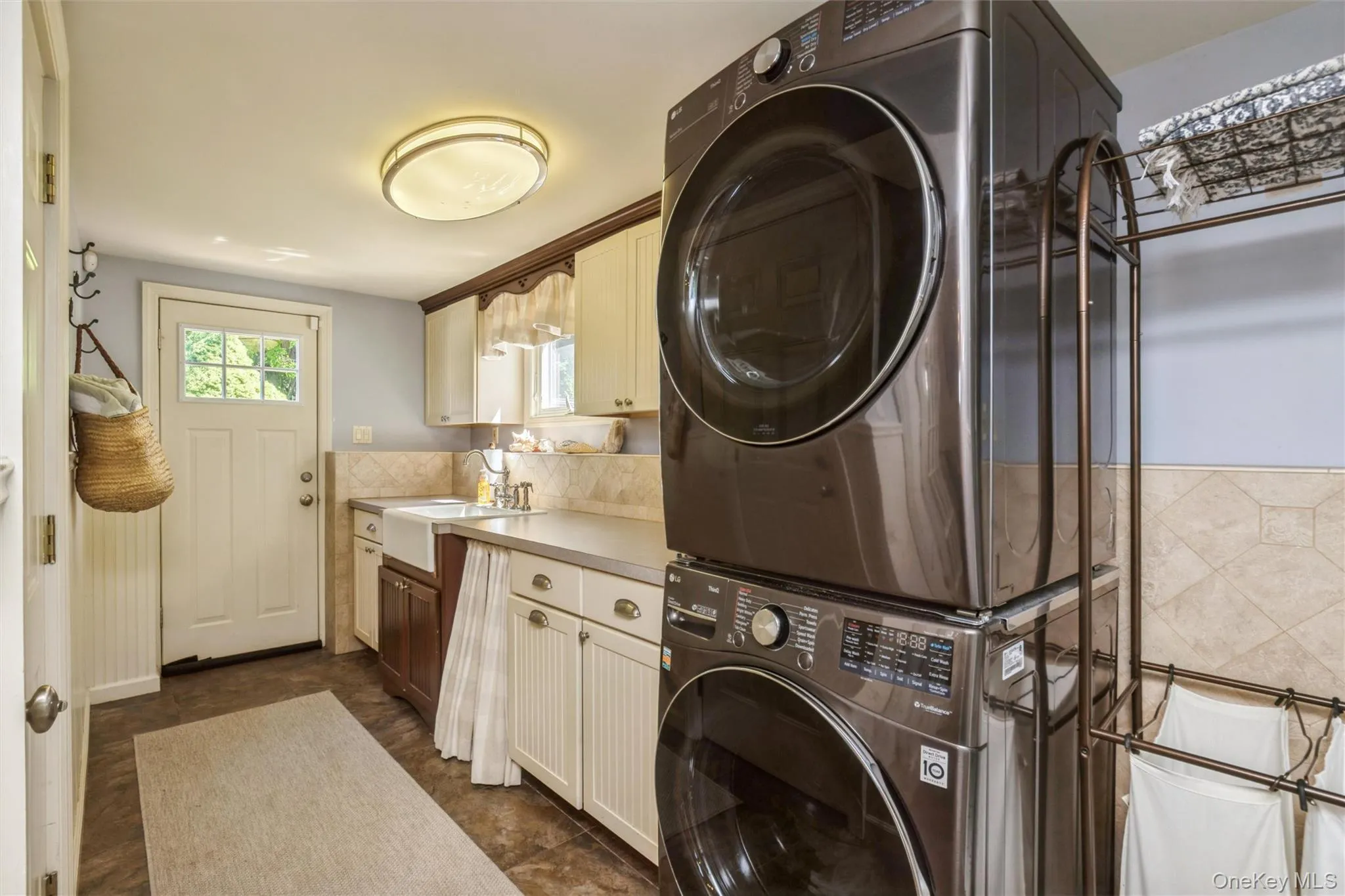 Lower level mudroom & laundry room have dual access to the yard and the attached one car garage. Lower level mudroom & laundry room have dual access to the yard and the attached one car garage.