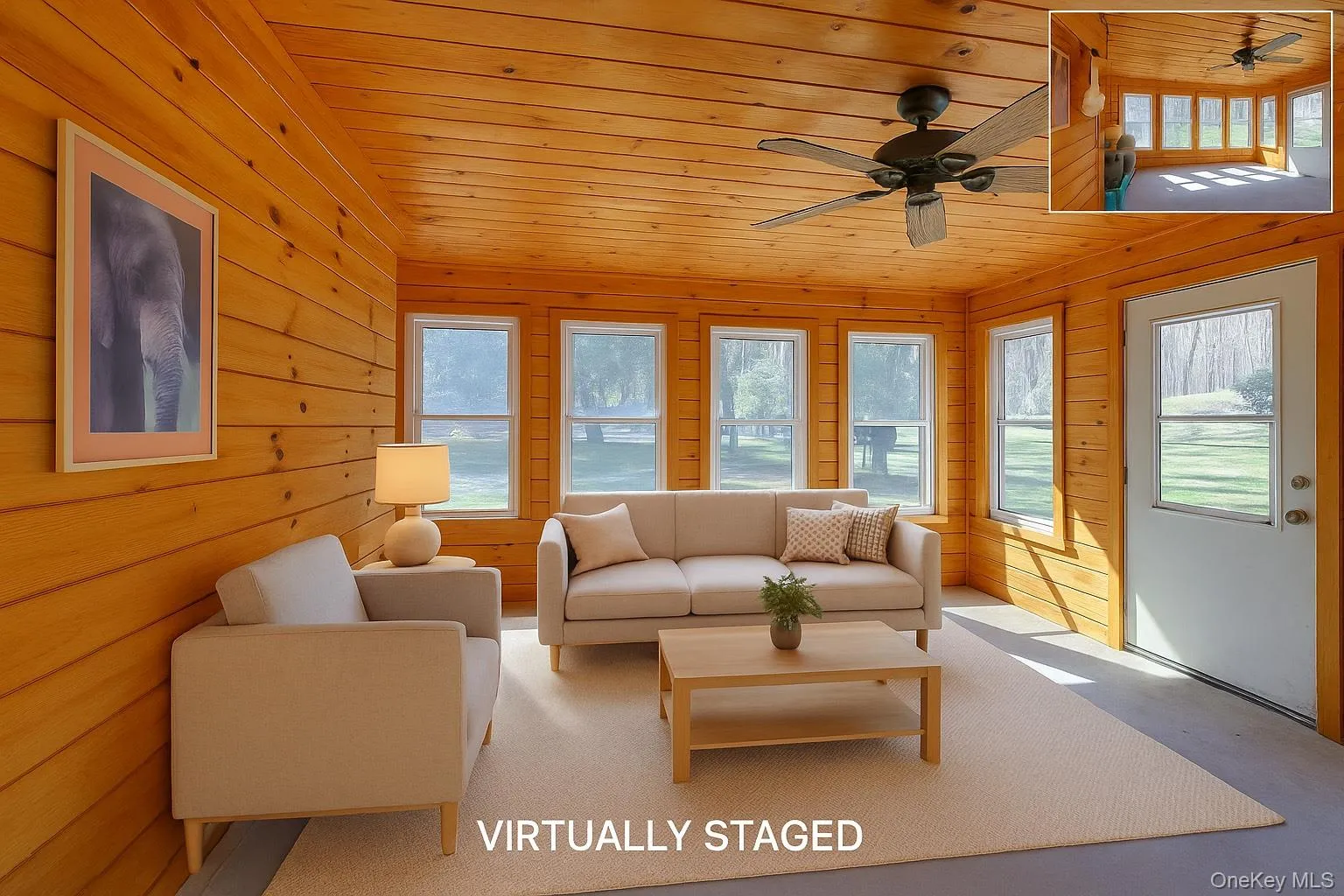 Living area with a ceiling fan, plenty of natural light, wooden ceiling, and wood walls Living area with a ceiling fan, plenty of natural light, wooden ceiling, and wood walls