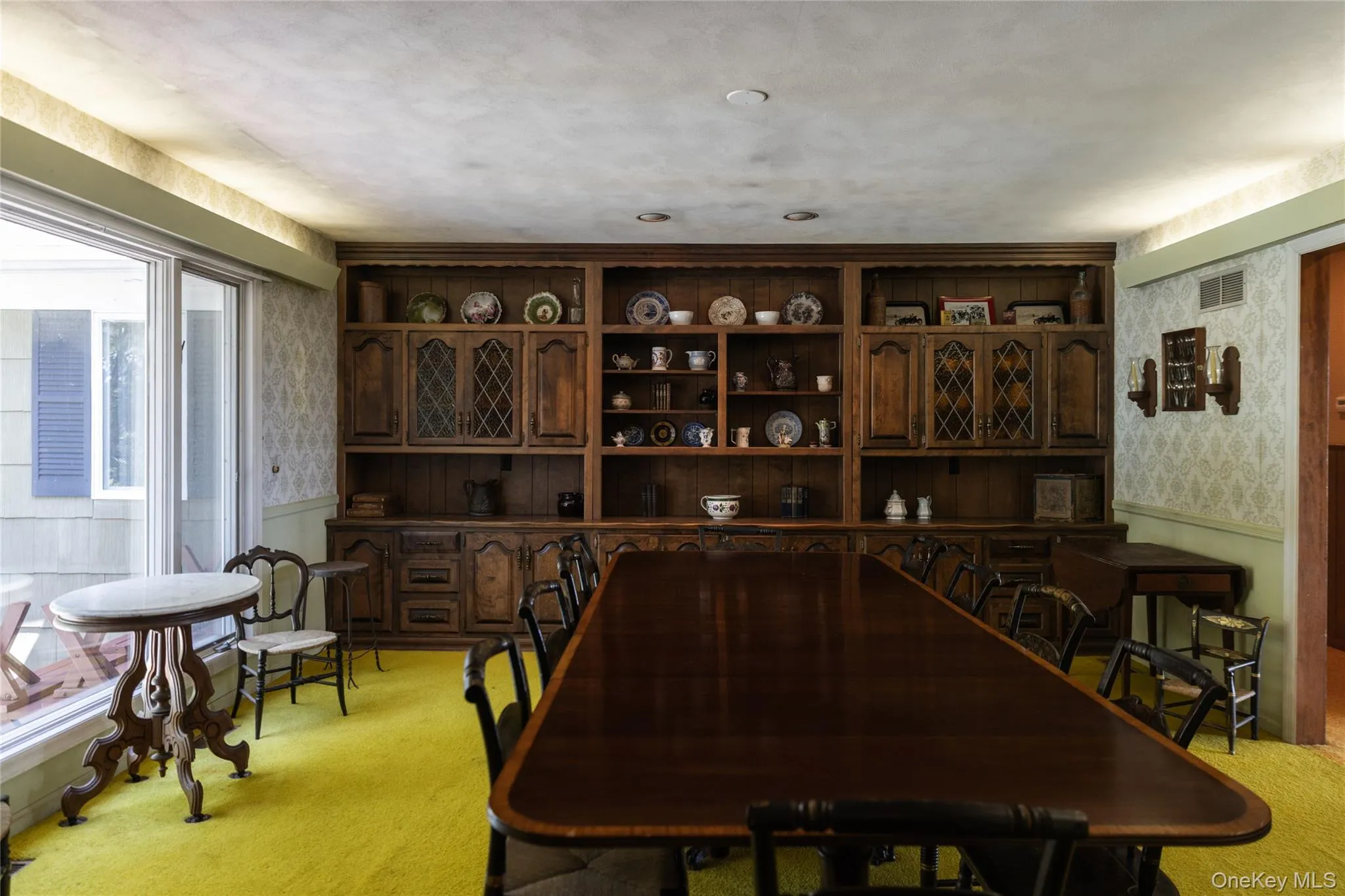 Large Formal Dining room with built-in wood cabinetry with glass-front uppers and open shelving Large Formal Dining room with built-in wood cabinetry with glass-front uppers and open shelving