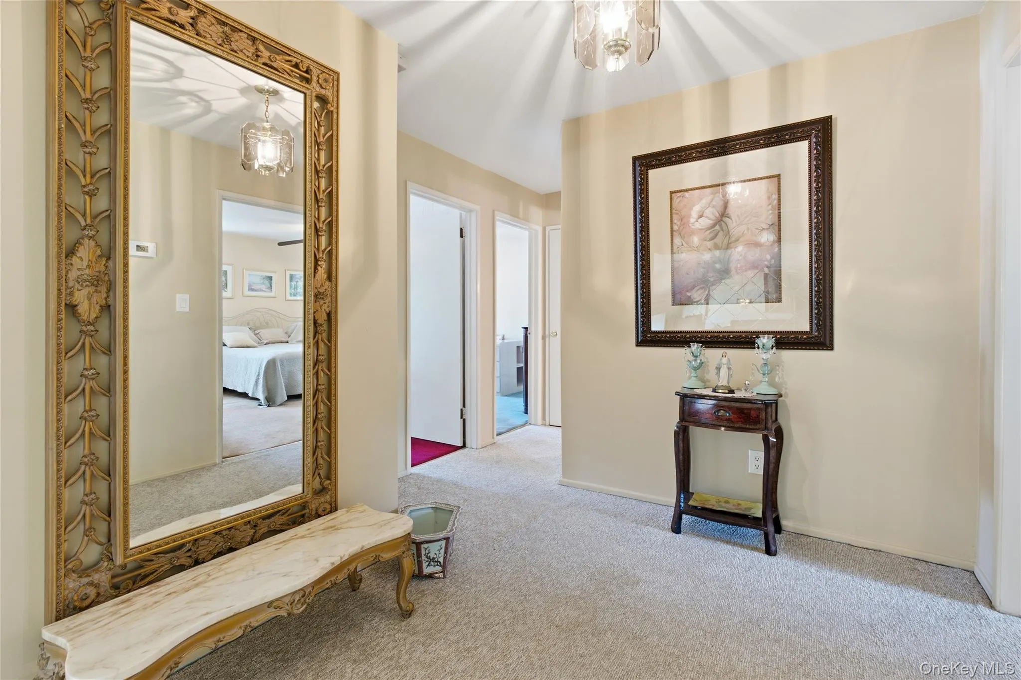 Hallway on upper level leading to 3 bedrooms including primary bedroom and full bathroom with double sink Hallway on upper level leading to 3 bedrooms including primary bedroom and full bathroom with double sink