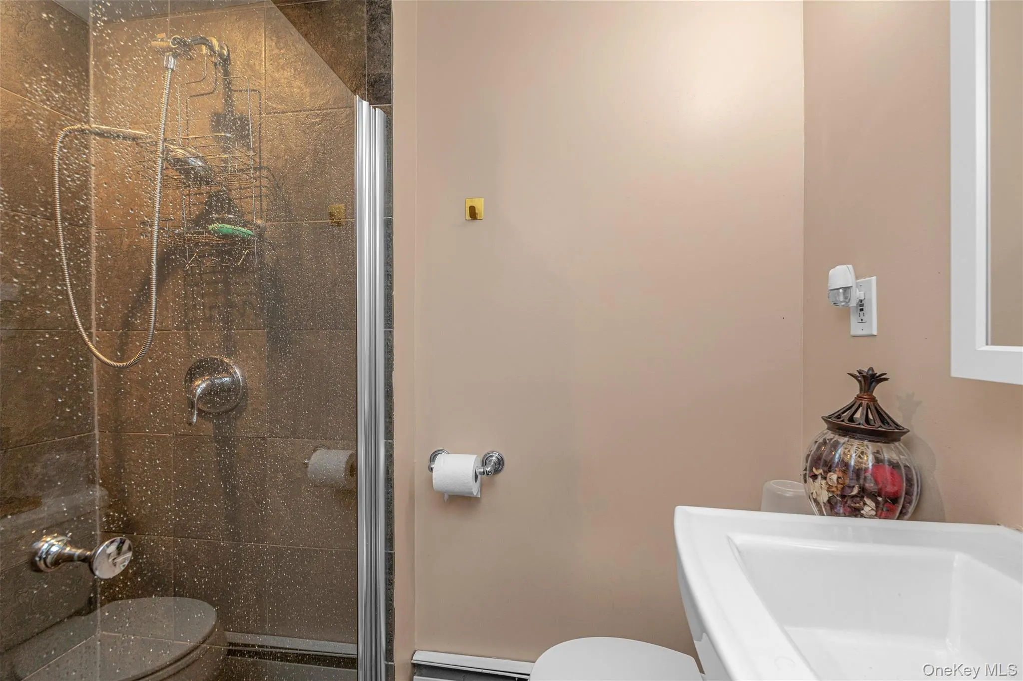 Full bath featuring a sink and a stall shower Full bath featuring a sink and a stall shower
