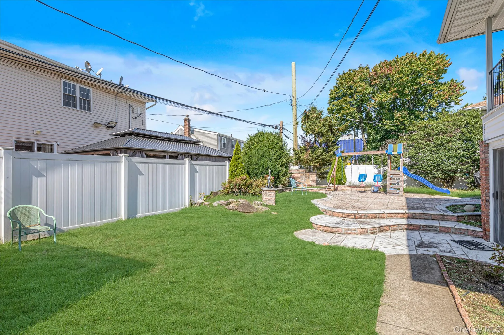 View of yard featuring a playground and a patio View of yard featuring a playground and a patio