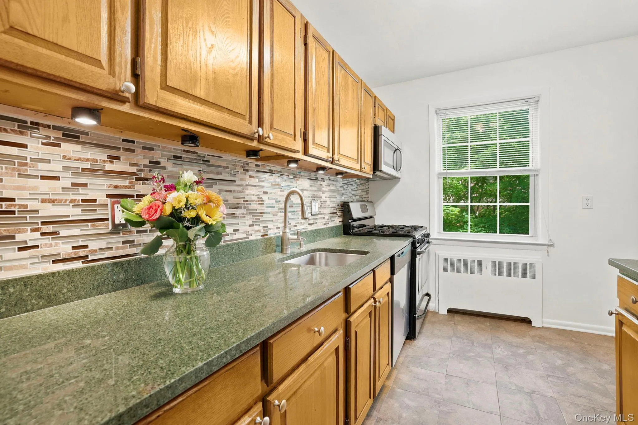 The renovated kitchen has granite countertops, undermount stainless steel sink and under cabinet lighting to create a great workspace area The renovated kitchen has granite countertops, undermount stainless steel sink and under cabinet lighting to create a great workspace area