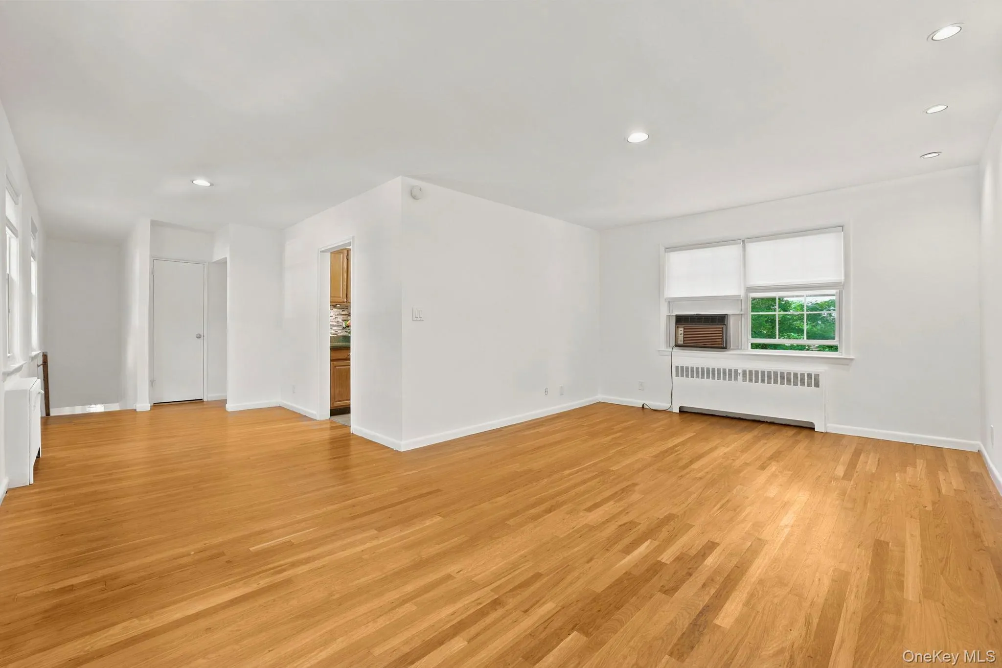 Expansive view of the living room and dining area with windows facing both north and south, allowing great ventilation Expansive view of the living room and dining area with windows facing both north and south, allowing great ventilation