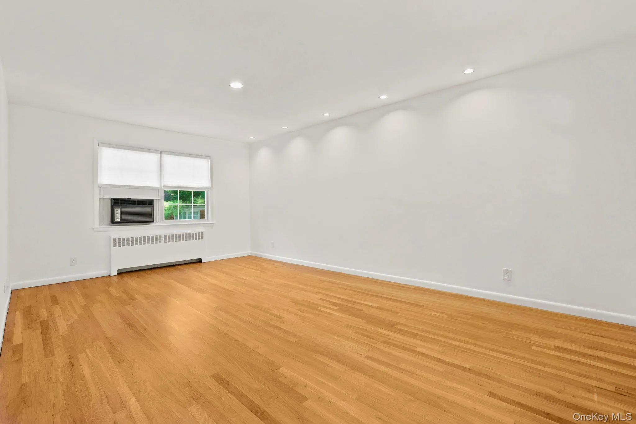 The living room has recess lighting and tree-top views from the windows on both the north and south side The living room has recess lighting and tree-top views from the windows on both the north and south side