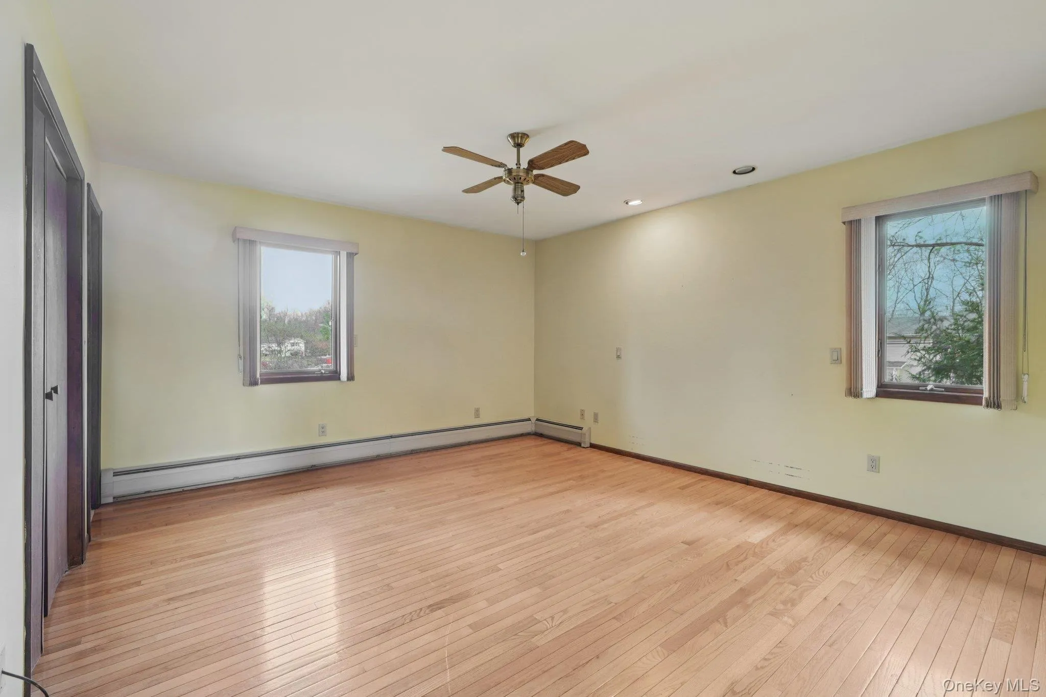 Unfurnished bedroom featuring light wood-style flooring, baseboard heating, recessed lighting, and ceiling fan Unfurnished bedroom featuring light wood-style flooring, baseboard heating, recessed lighting, and ceiling fan