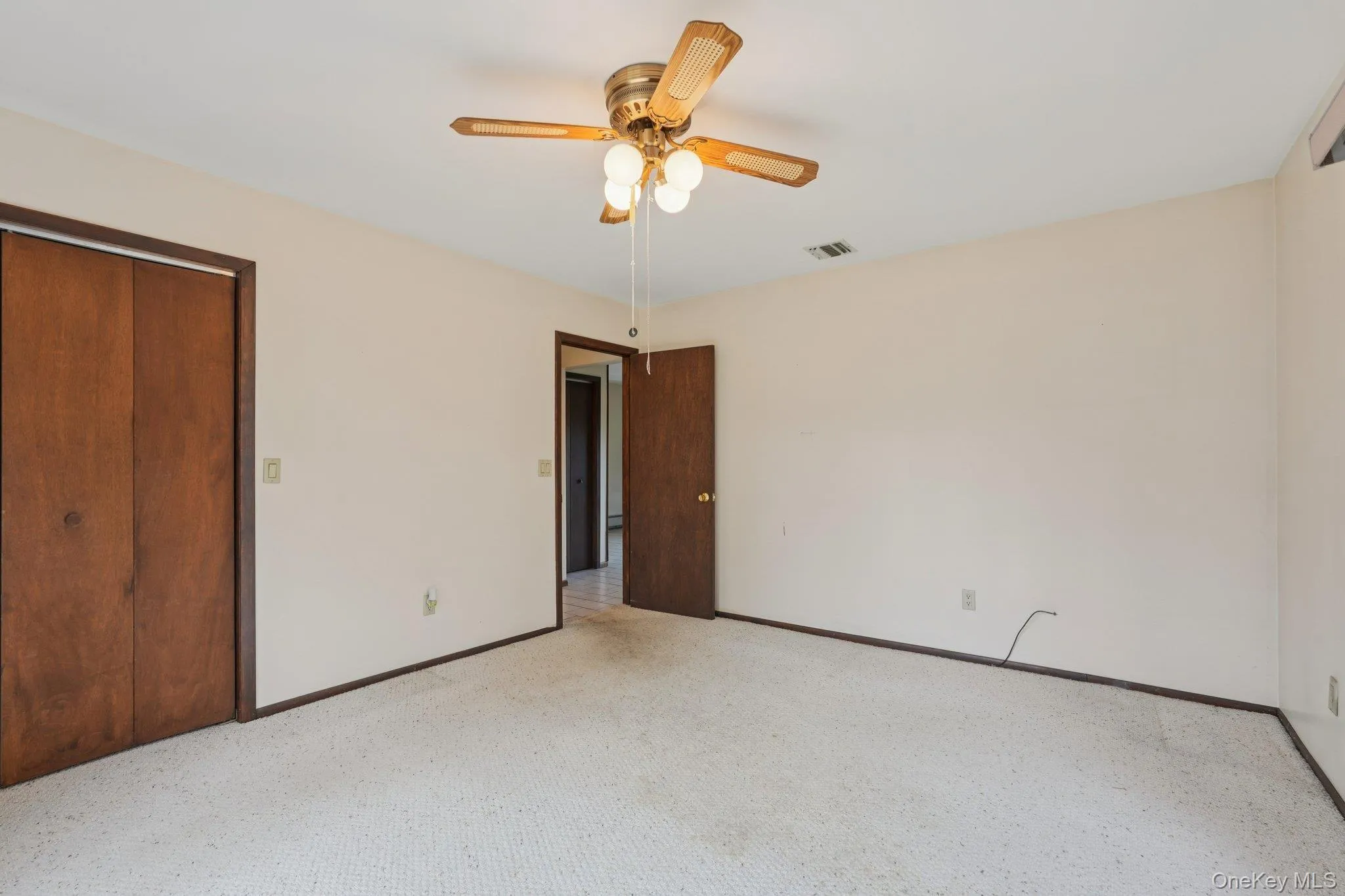 Unfurnished bedroom featuring carpet flooring, ceiling fan, and a closet Unfurnished bedroom featuring carpet flooring, ceiling fan, and a closet