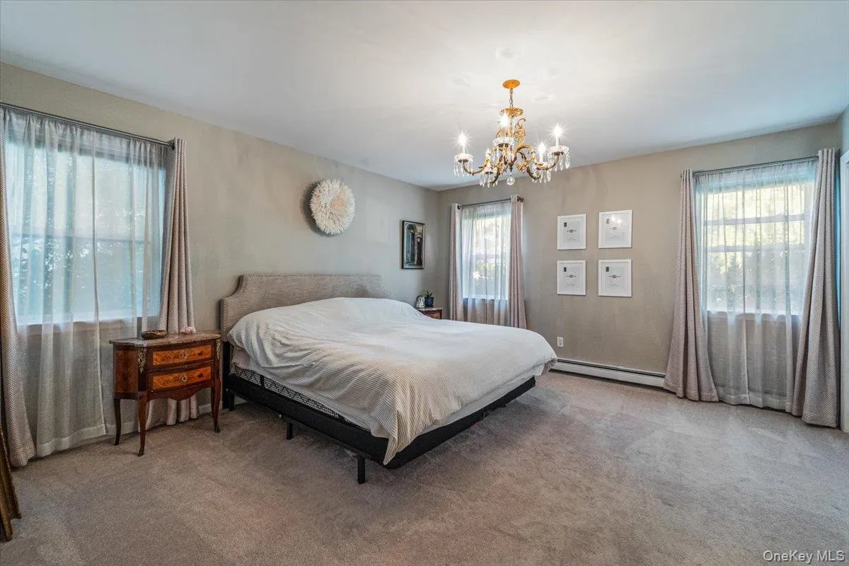 Expansive room with neutral carpeting and light-toned walls Expansive room with neutral carpeting and light-toned walls