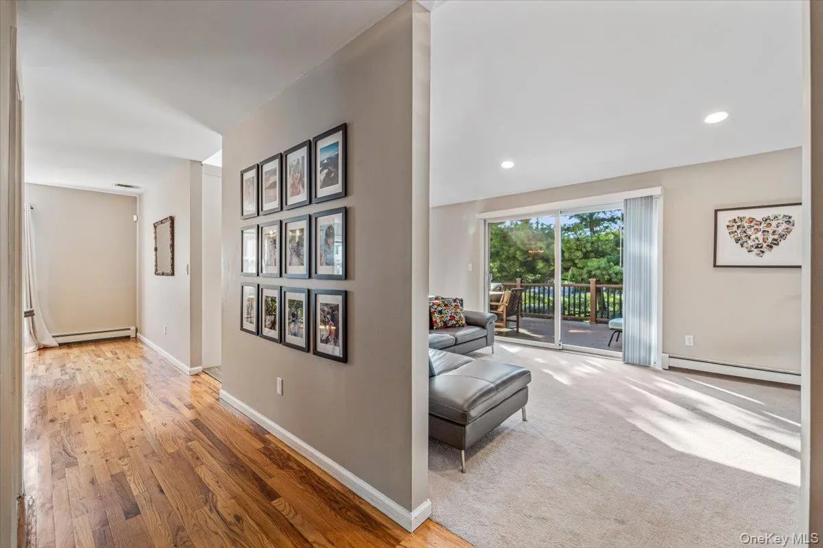 Living area featuring light-toned carpeting and recessed lighting Living area featuring light-toned carpeting and recessed lighting
