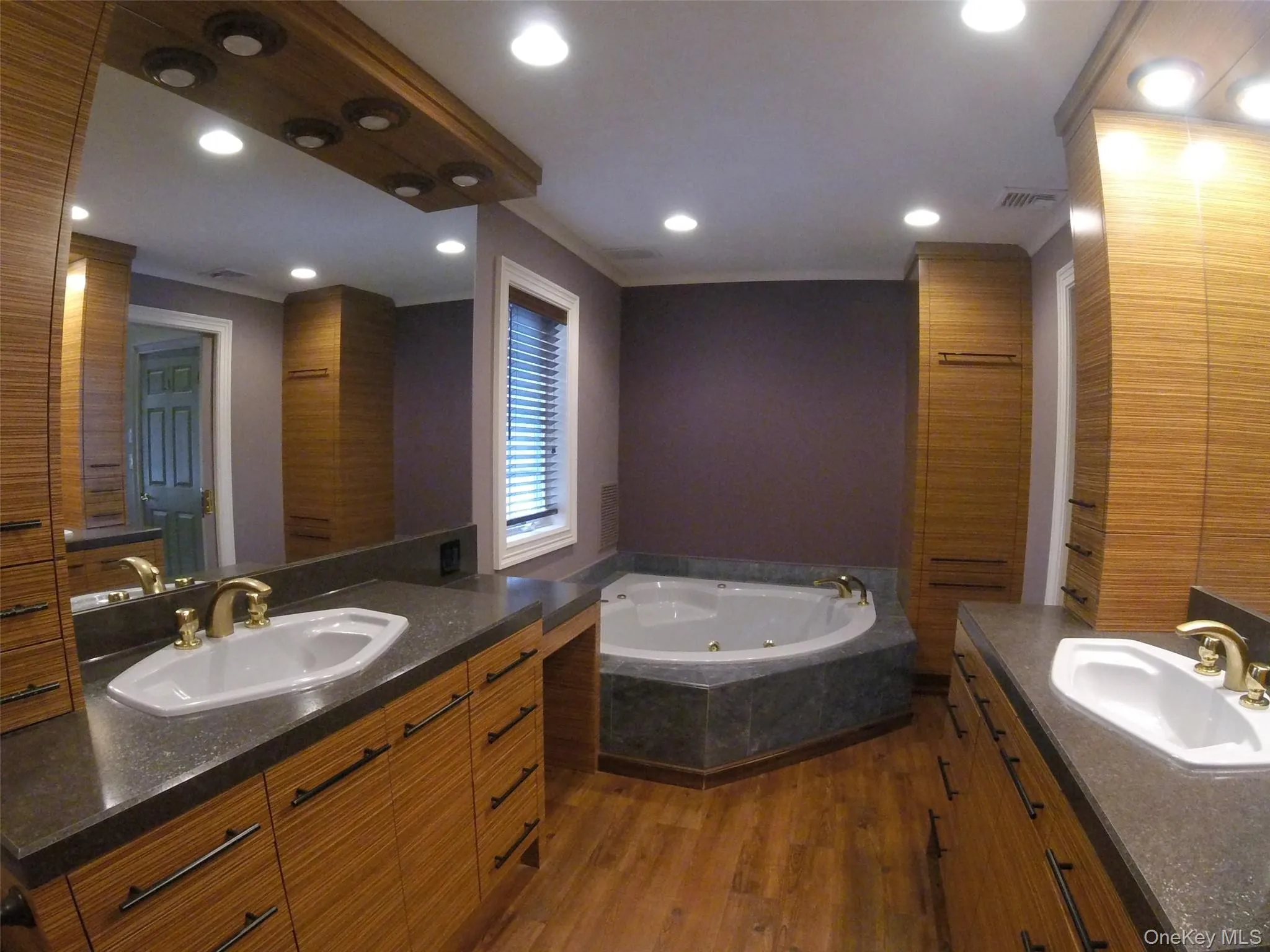 Spa-inspired bathroom featuring a built-in corner soaking tub Spa-inspired bathroom featuring a built-in corner soaking tub