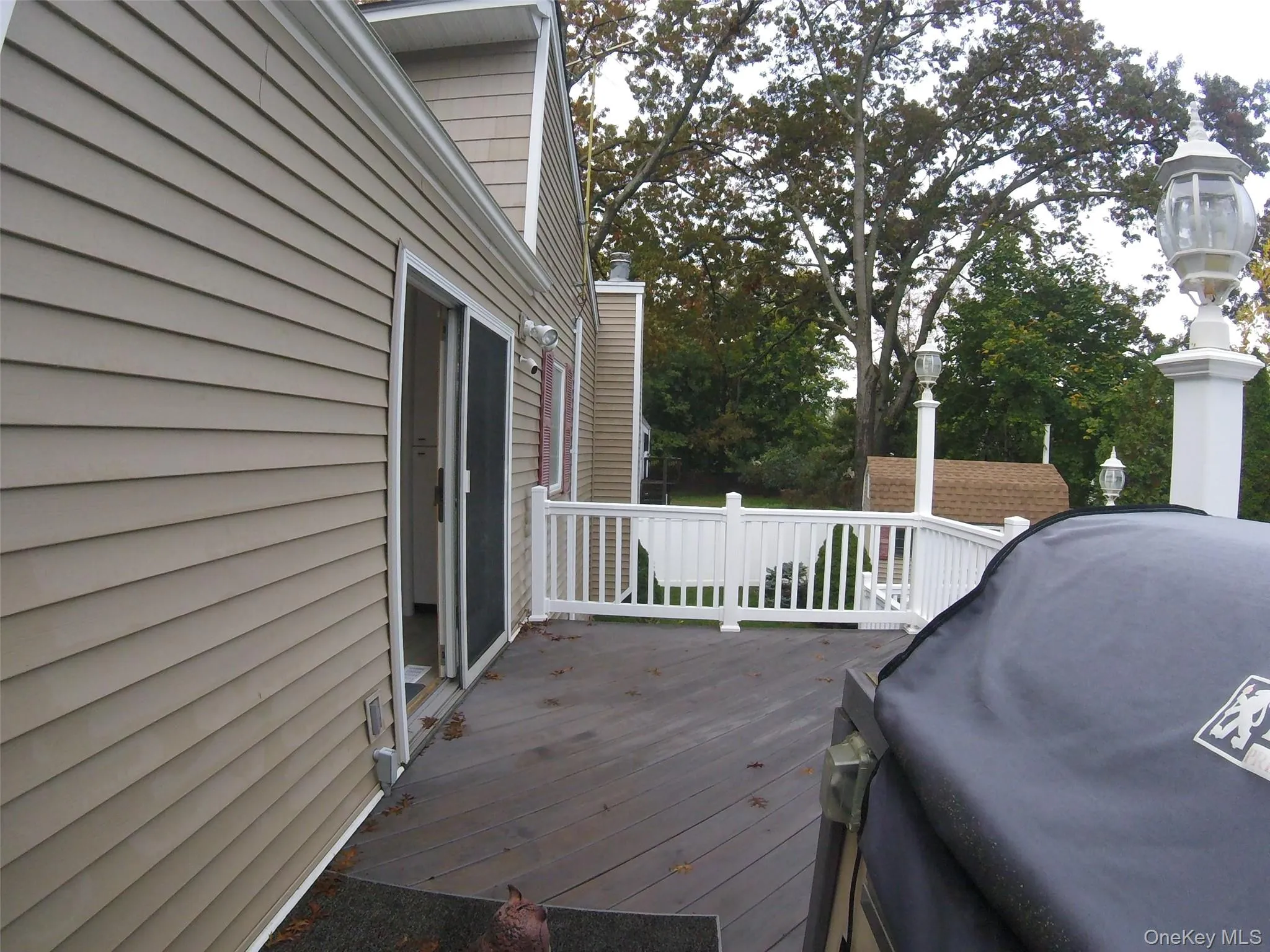 Spacious outdoor deck with composite decking and white railings Spacious outdoor deck with composite decking and white railings