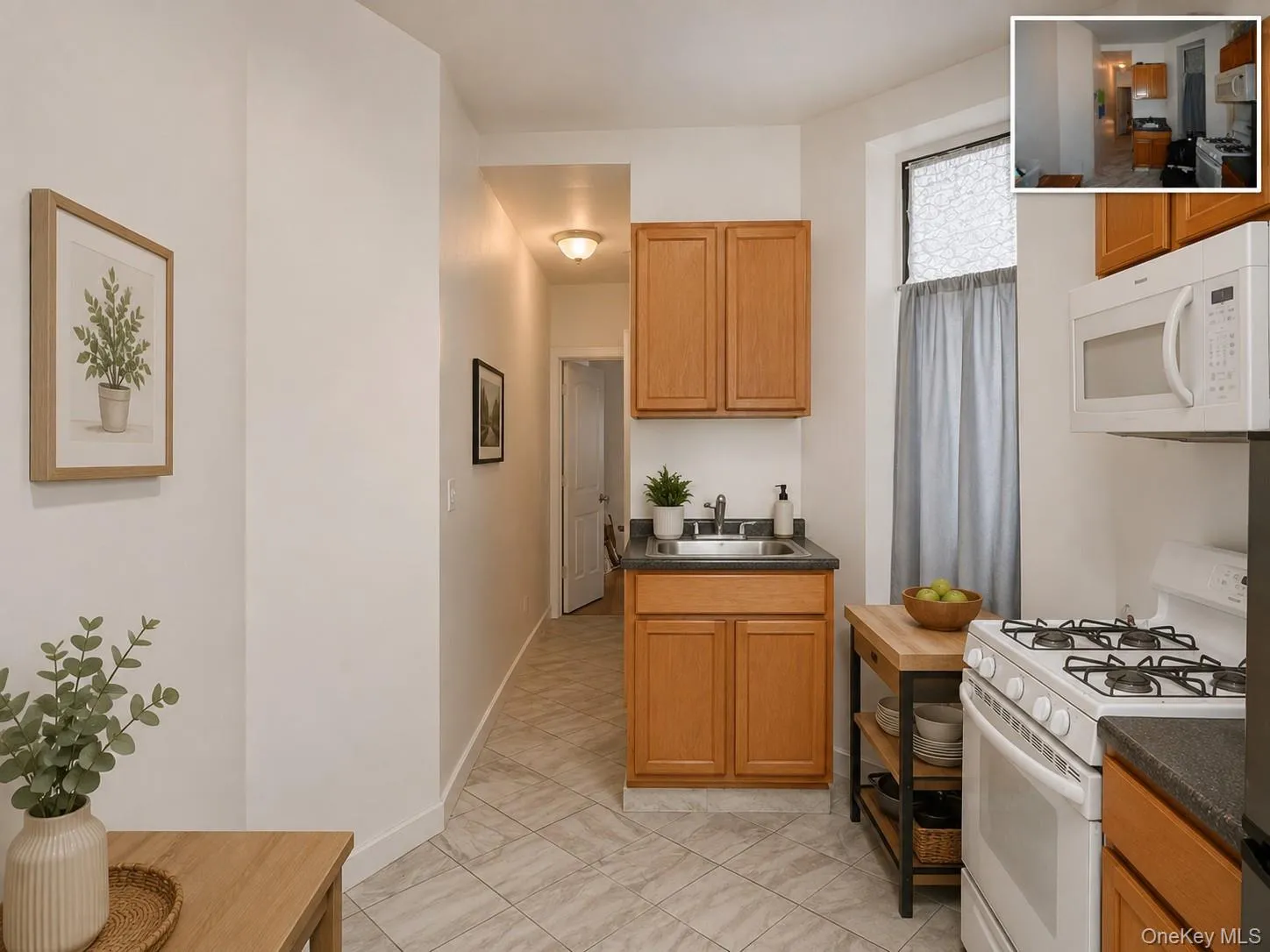 Kitchen featuring wood-finish cabinetry, white appliances, and a stainless steel sink (virtually staged) Kitchen featuring wood-finish cabinetry, white appliances, and a stainless steel sink (virtually staged)