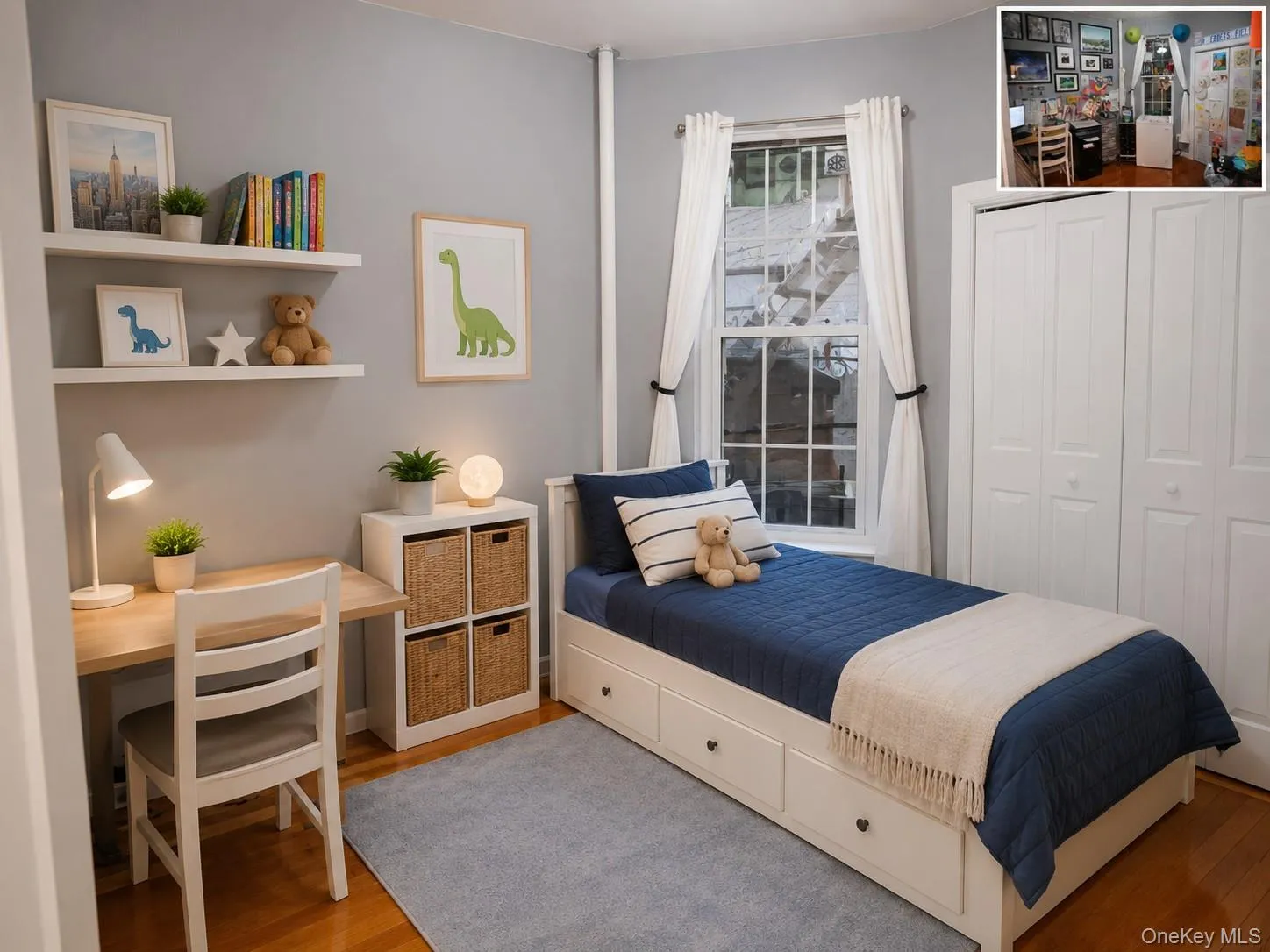 Light-filled bedroom featuring wood-finish flooring, a double window with white trim, built-in shelving, and a white bi-fold closet (virtually staged) Light-filled bedroom featuring wood-finish flooring, a double window with white trim, built-in shelving, and a white bi-fold closet (virtually staged)