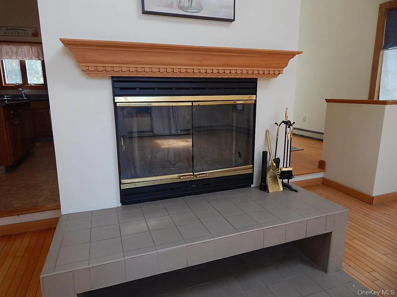 Raised hearth fireplace with oak mantel. Raised hearth fireplace with oak mantel.