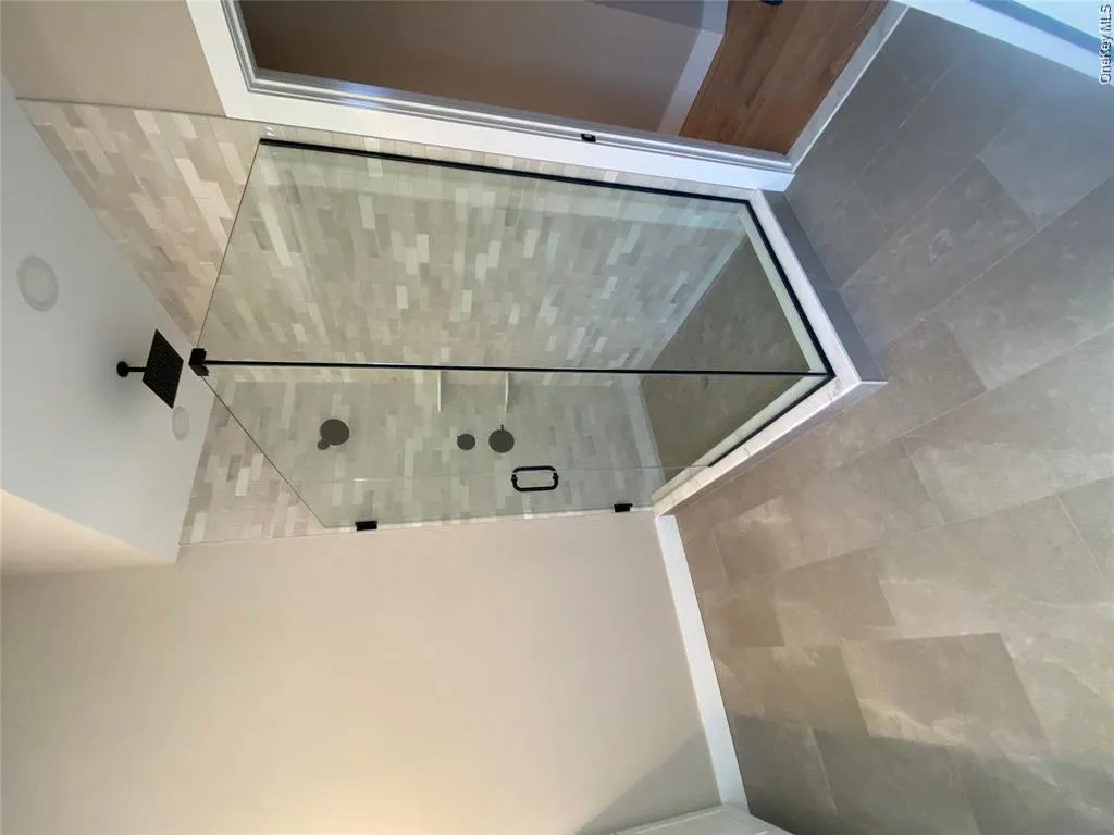 The walk-in shower offers a clean, modern, design for a comfortable daily routine. The walk-in shower offers a clean, modern, design for a comfortable daily routine.