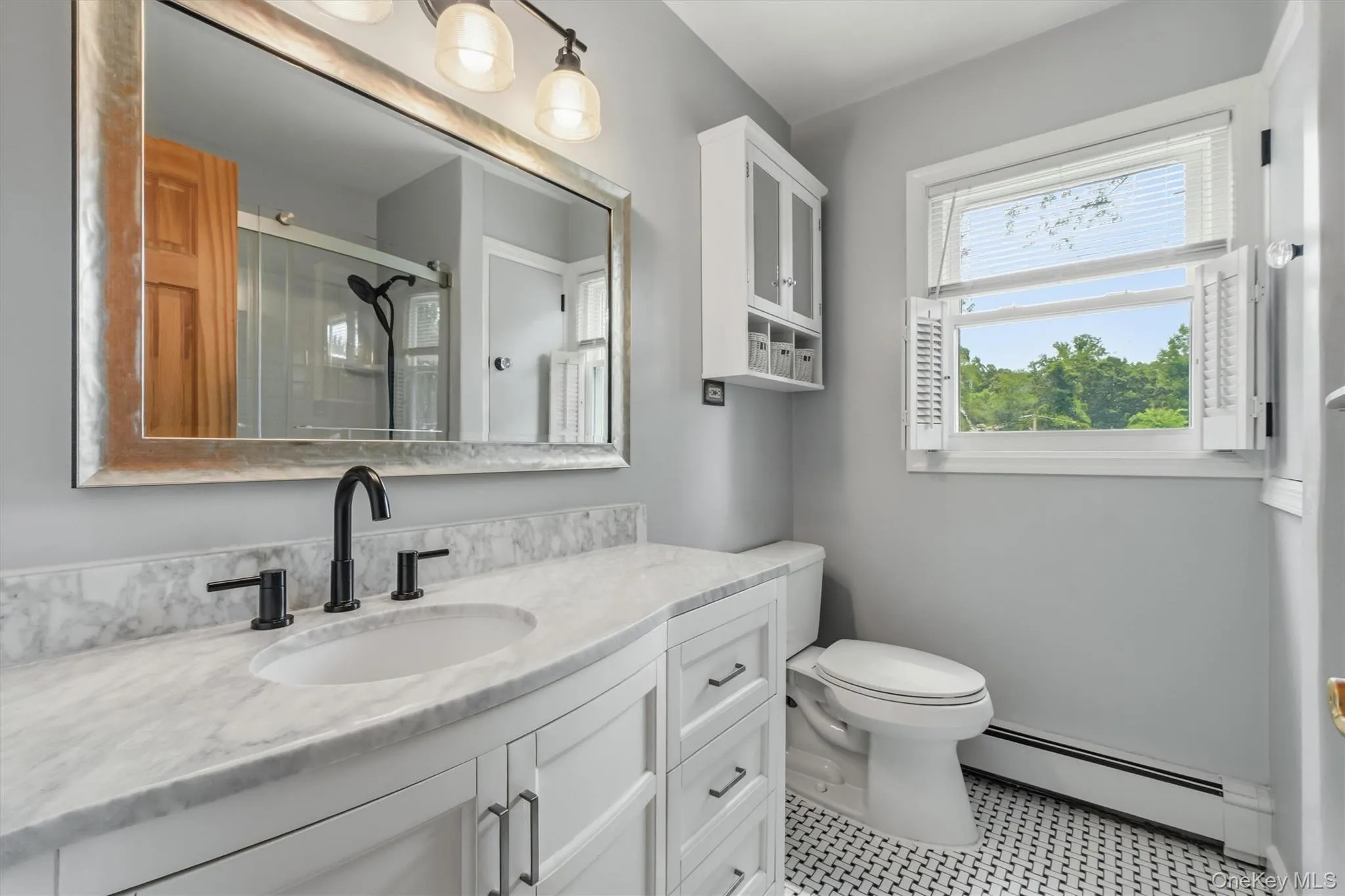 Beautifully updated hall bath - marble counter tops, tiled flooring . Beautifully updated hall bath - marble counter tops, tiled flooring .