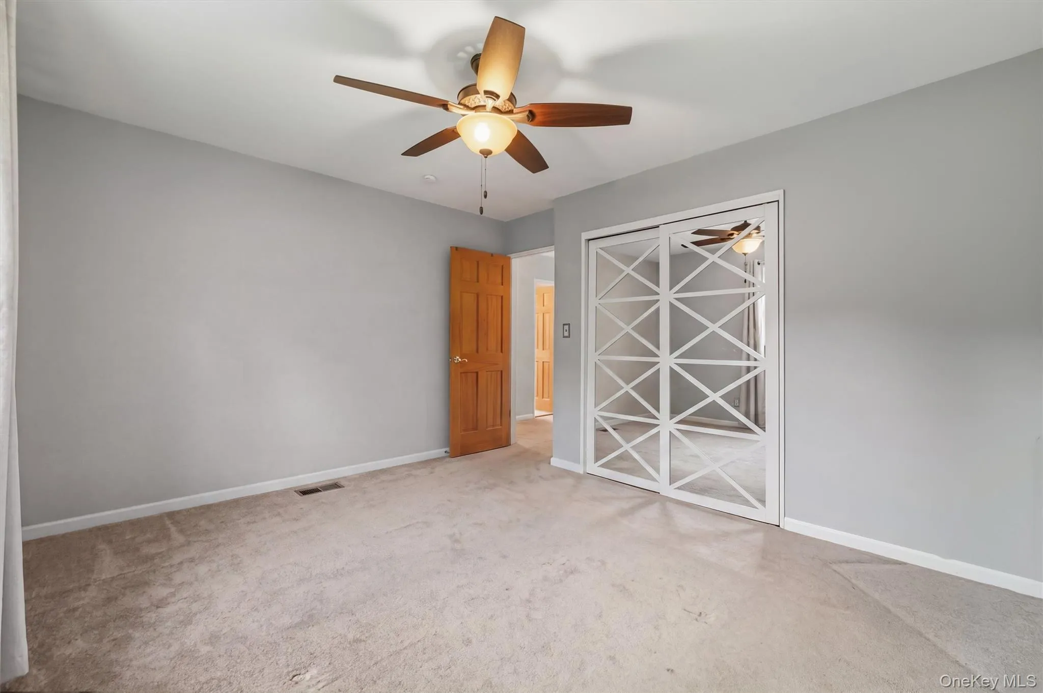 Primary Bedroom w/mirrored sliding closet, 2 windows & ceiling fan Primary Bedroom w/mirrored sliding closet, 2 windows & ceiling fan