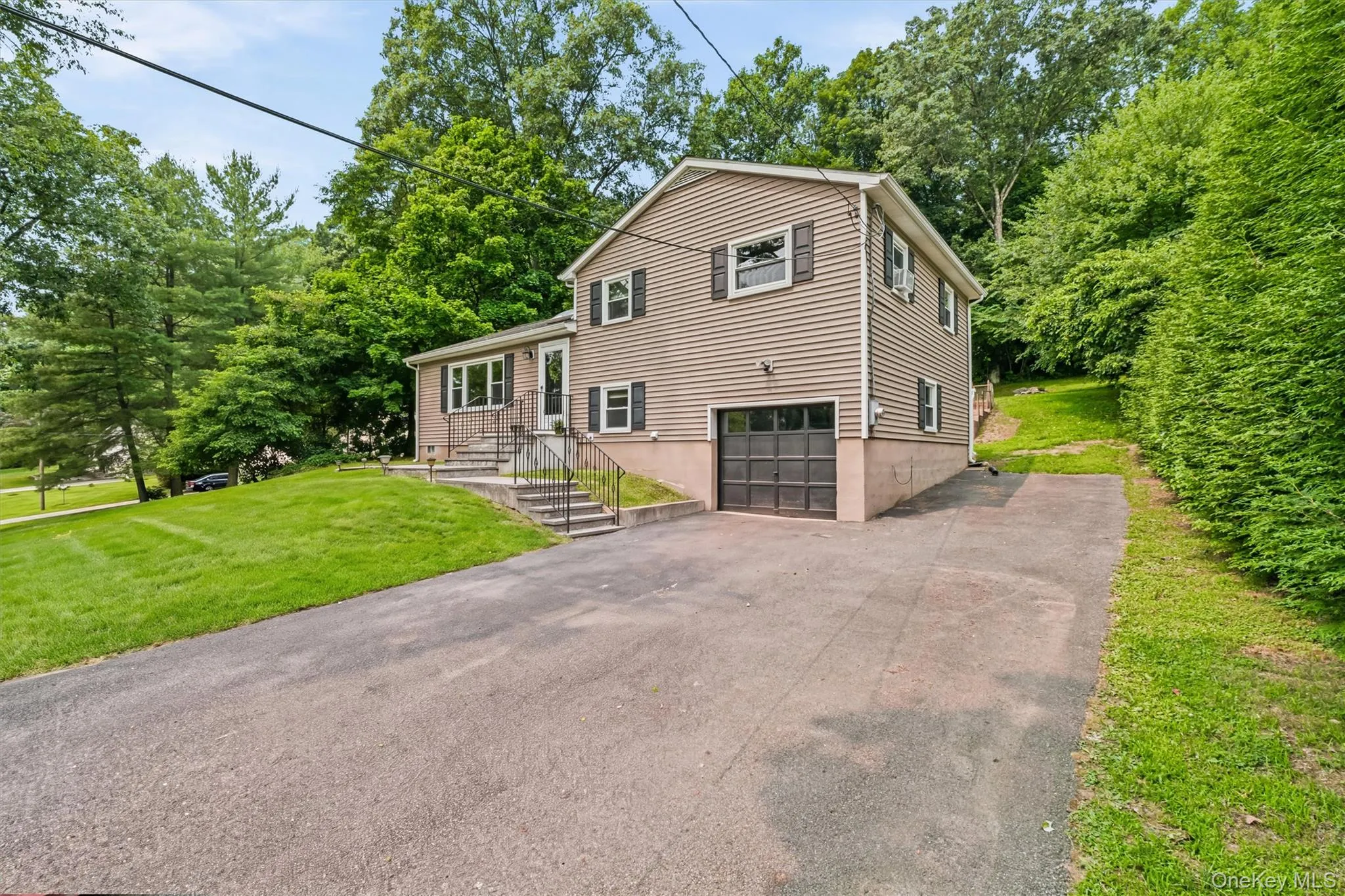 Large flat driveway, one-car garage and extra parking pad on side. Large flat driveway, one-car garage and extra parking pad on side.