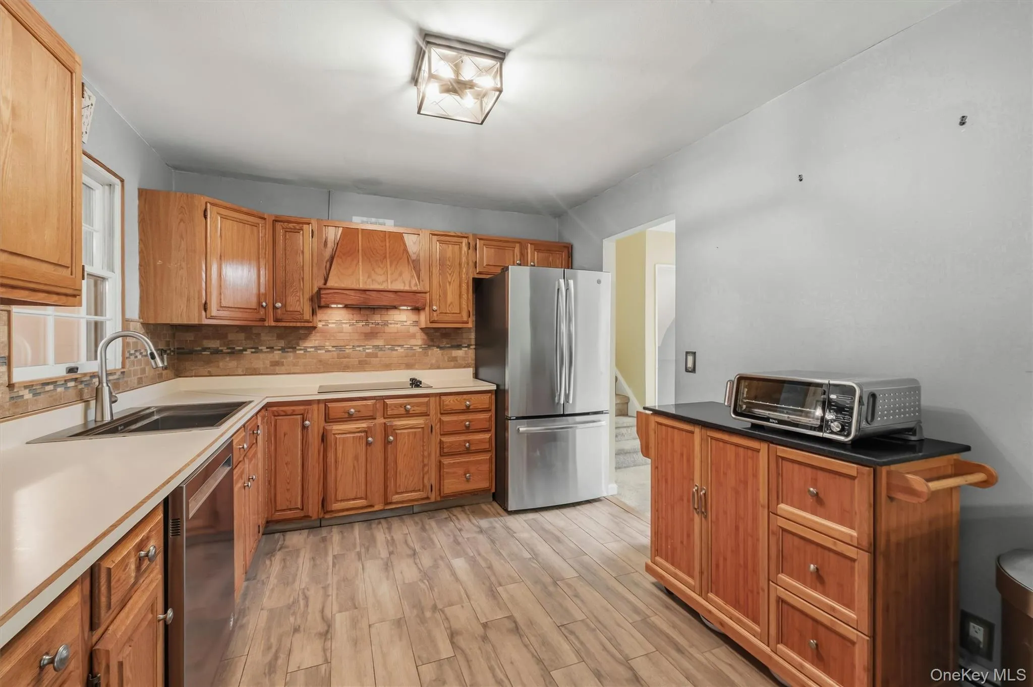 Nice sized kitchen with good cabinet space and tiled floor & backsplash Nice sized kitchen with good cabinet space and tiled floor & backsplash