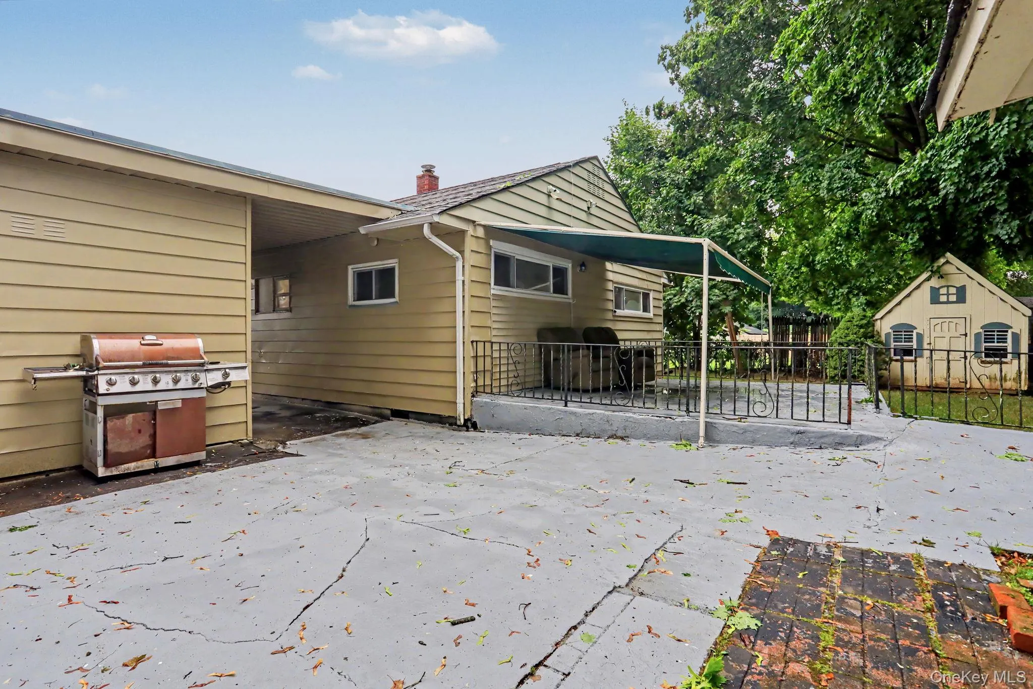 Large patio with awning and BBQ area. Large patio with awning and BBQ area.