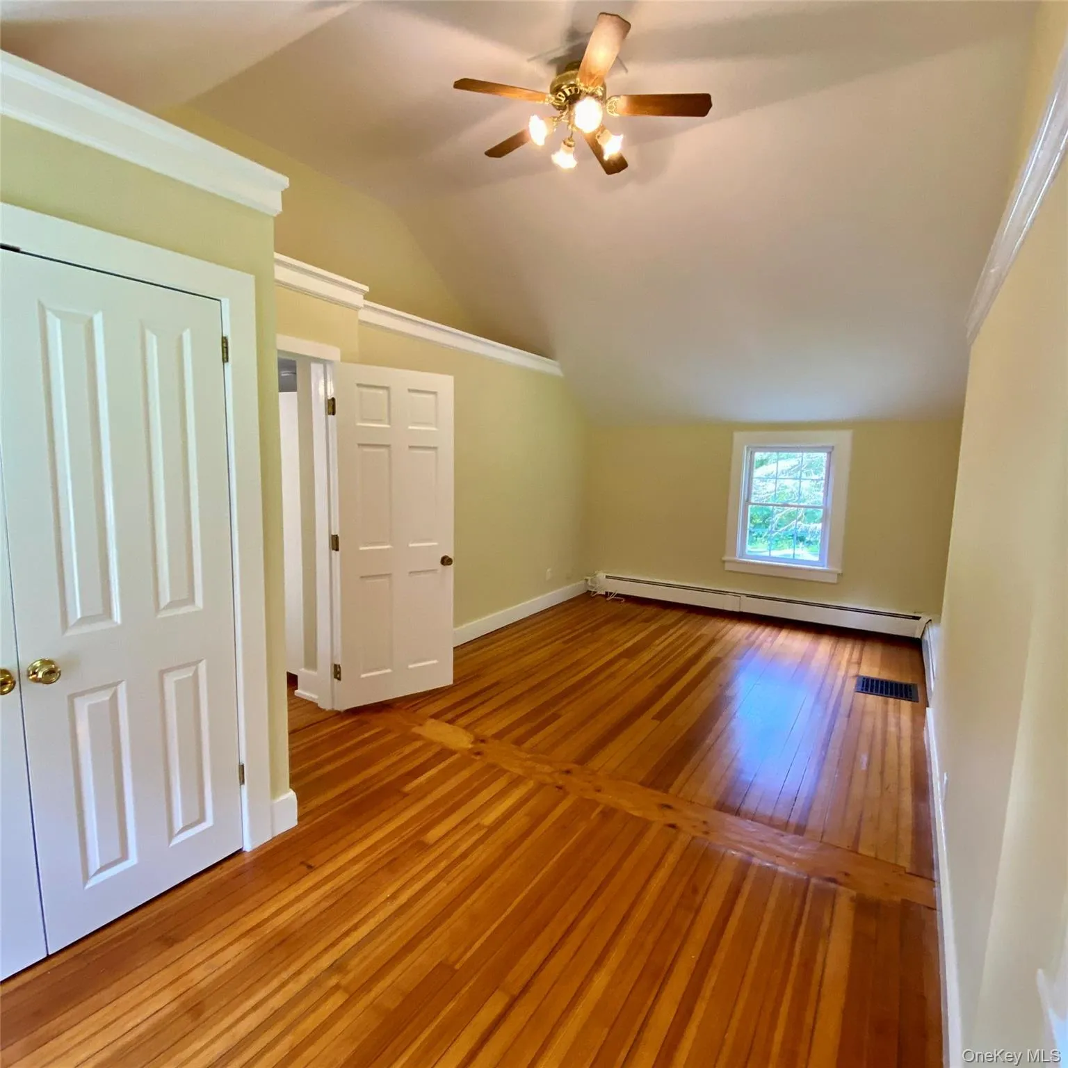 Spacious primary bedroom with high ceilings, fir floors, ceiling fan Spacious primary bedroom with high ceilings, fir floors, ceiling fan