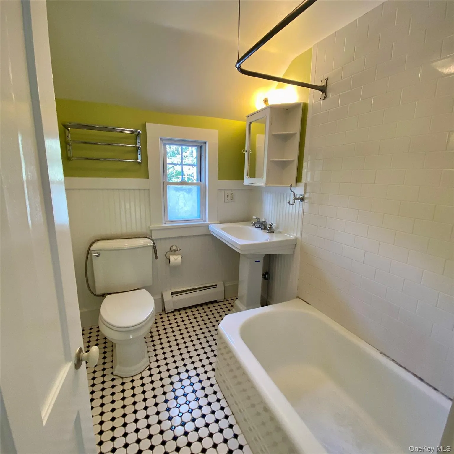 Full bath with shower, tile floor and wainscote. Full bath with shower, tile floor and wainscote.