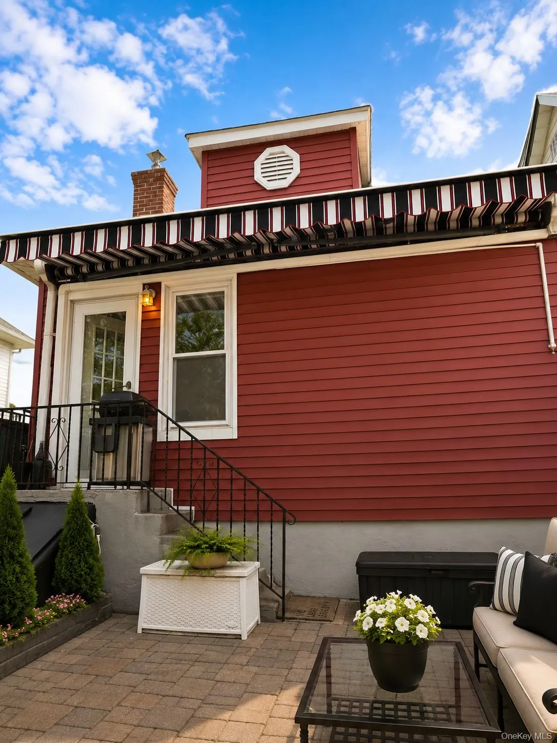 Virtually staged patio-paved yard with remote-control retractable awning and entrance to kitchen. Virtually staged patio-paved yard with remote-control retractable awning and entrance to kitchen.